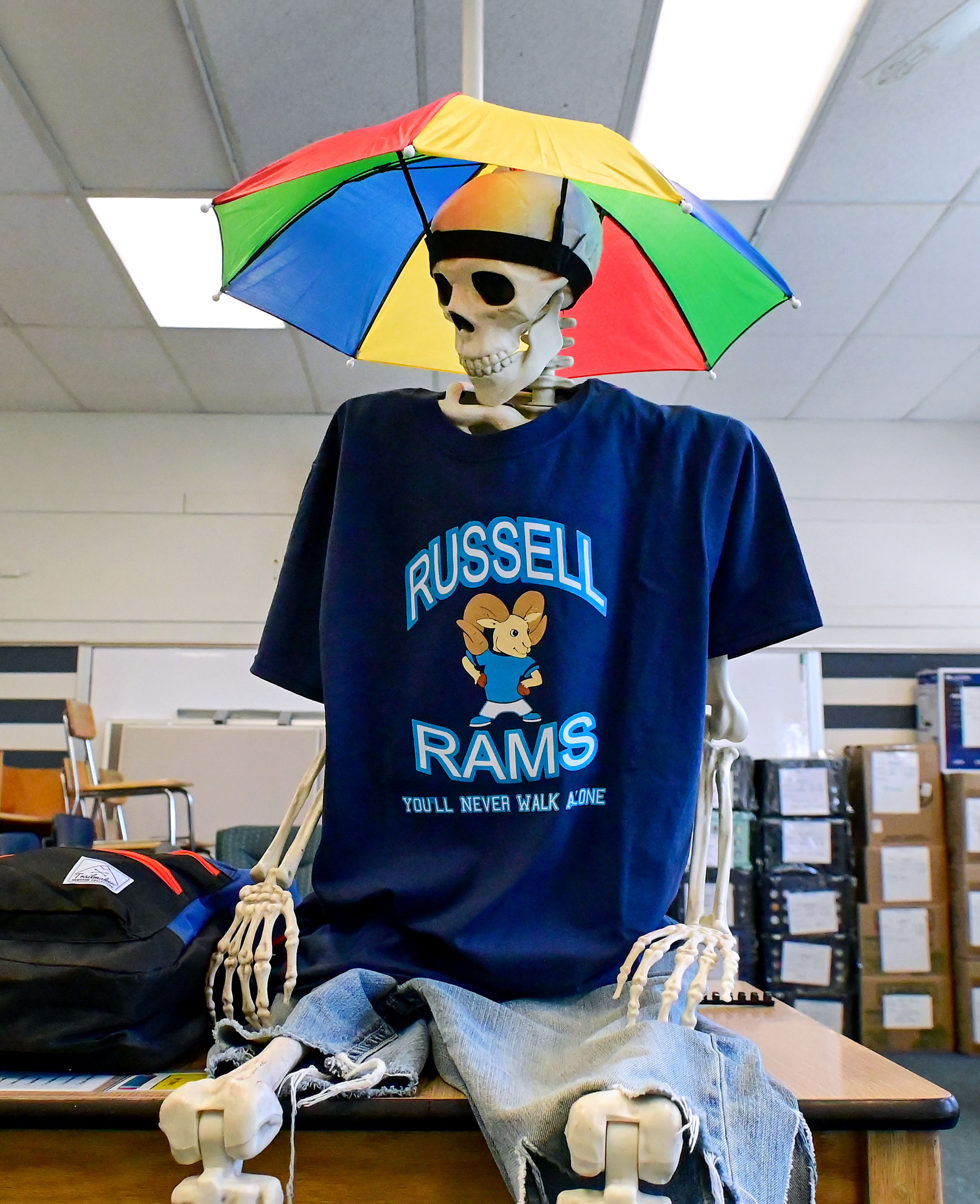 Cliff, a skeleton dressed in Russell Rams gear, sits on the top of a desk in a packed up classroom of Russell Elementary on Thursday.