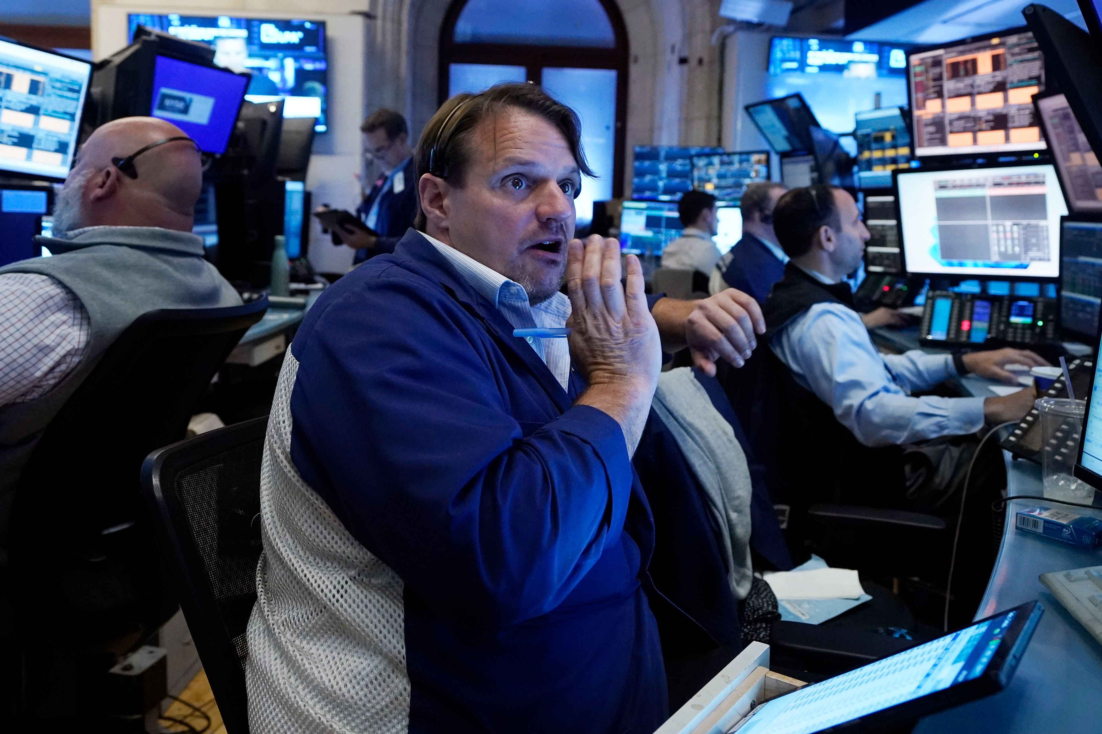 FILE - Trader Michael Milano, center, works with colleagues on the floor of the New York Stock Exchange on May 30, 2024. World stocks are mixed on Friday, June 7, 2024, after a steady day on Wall Street as markets anticipate key U.S. jobs data to be revealed later in the day.