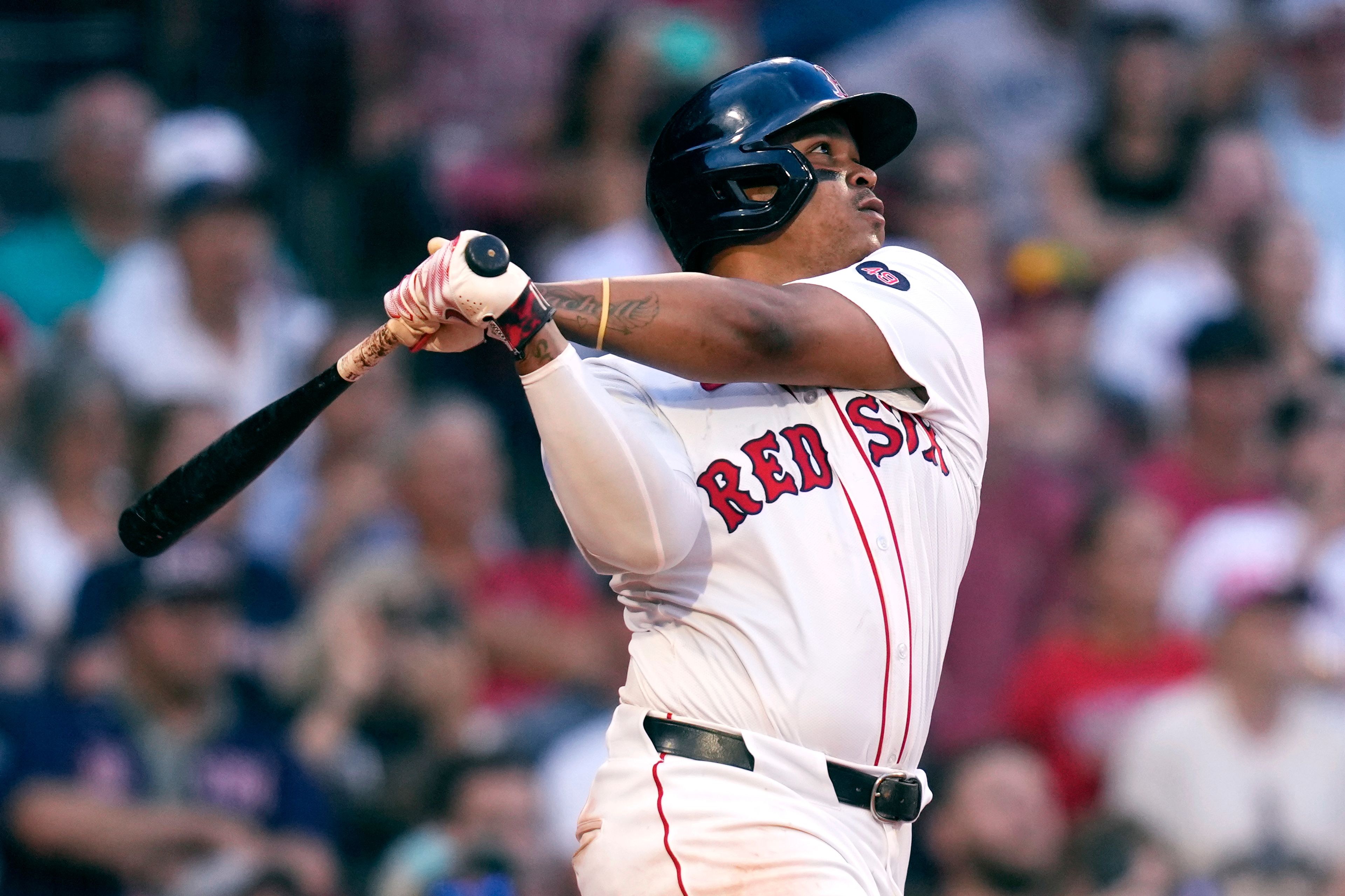 Boston Red Sox's Rafael Devers watches the flight of his game-winning RBI double, which drove in Tyler O'Neill, during the 10th inning of a baseball game against the Seattle Mariners, Wednesday, July 31, 2024, in Boston. (AP Photo/Charles Krupa)