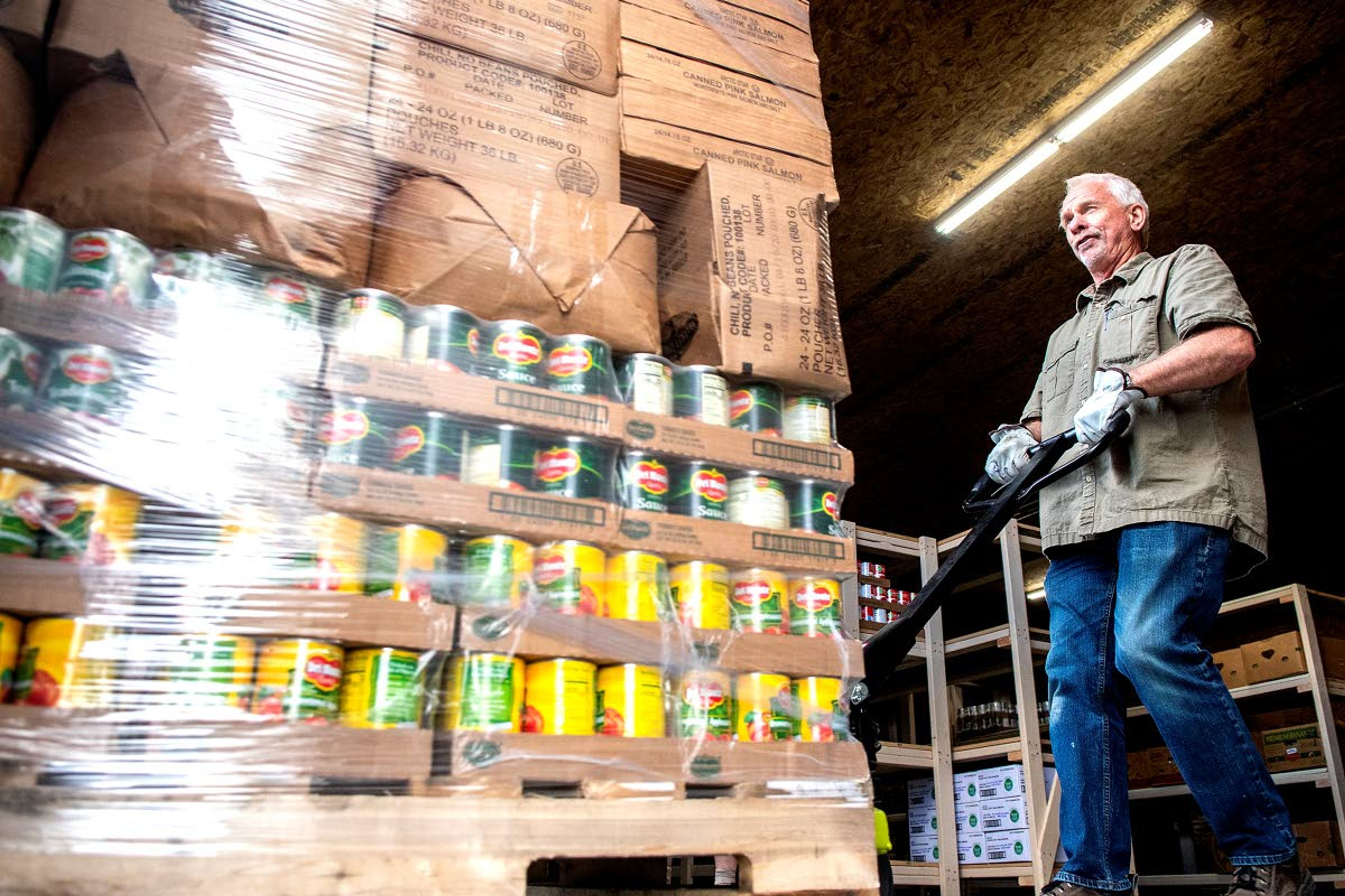 Ken Lefsaker pulls a pallet stacked with food from the truck into the new Camas Prairie Food Bank building in Grangeville as a new shipment from the Idaho Food Bank arrives.