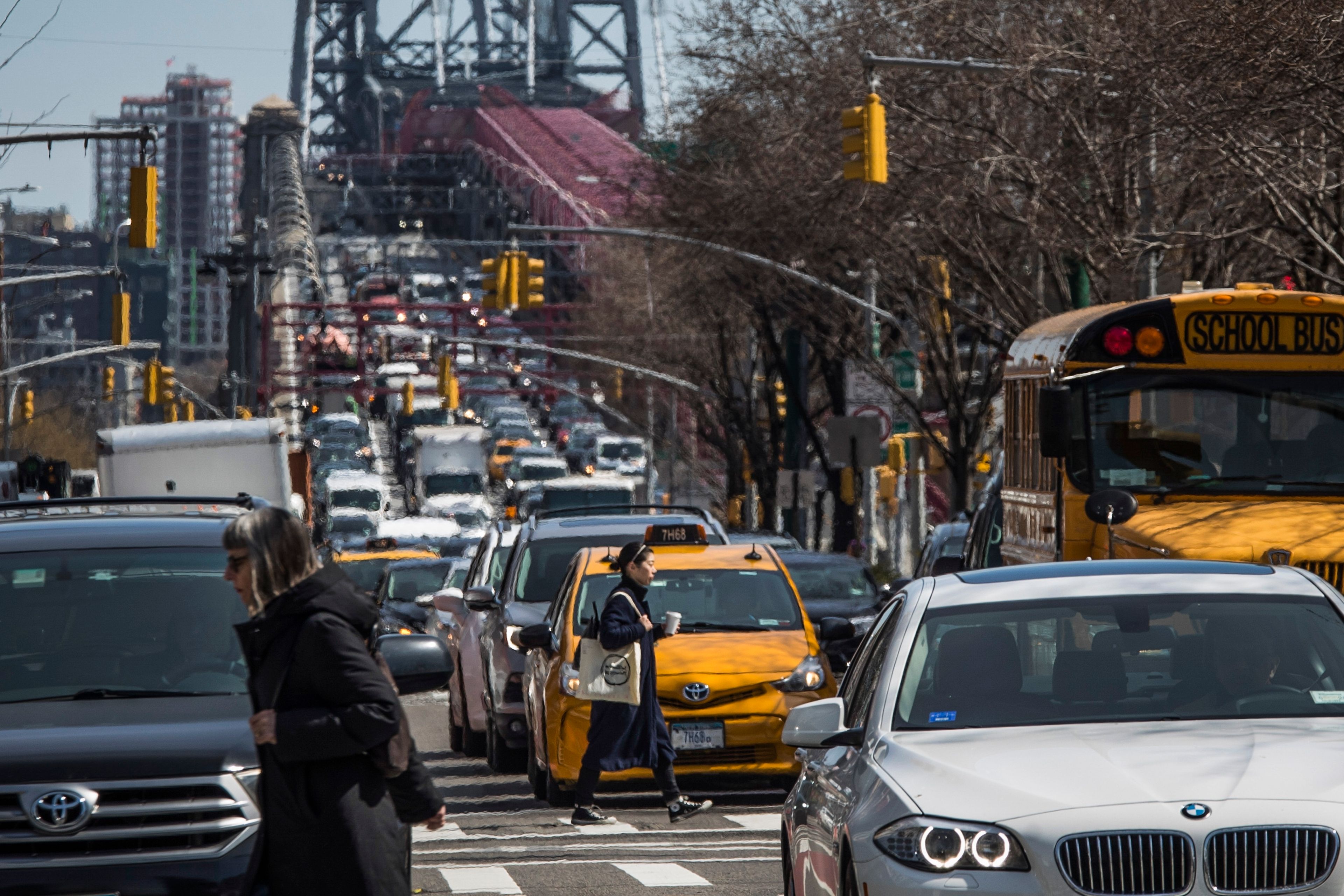 FILE - Pedestrians cross Delancey Street as congested traffic from Brooklyn enters Manhattan over the Williamsburg Bridge, March 28, 2019, in New York. New York Gov. Kathy Hochul on Wednesday, June 5, 2024 indefinitely delayed implementation of a plan to charge motorists big tolls to enter the core of Manhattan, just weeks before the nation's first “congestion pricing” system was set to launch.