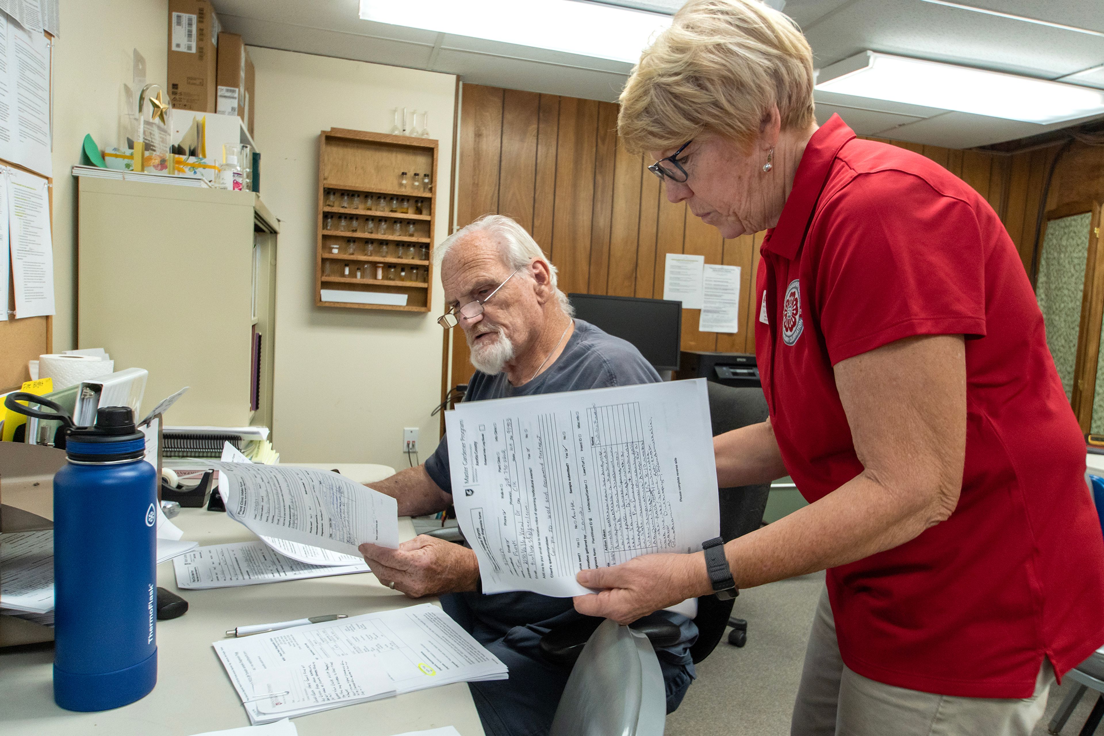 Asotin County Master Gardeners Ruth Monahan and Tom Van Horn look over questions sent in by residents during a clinic in Asotin September 13.