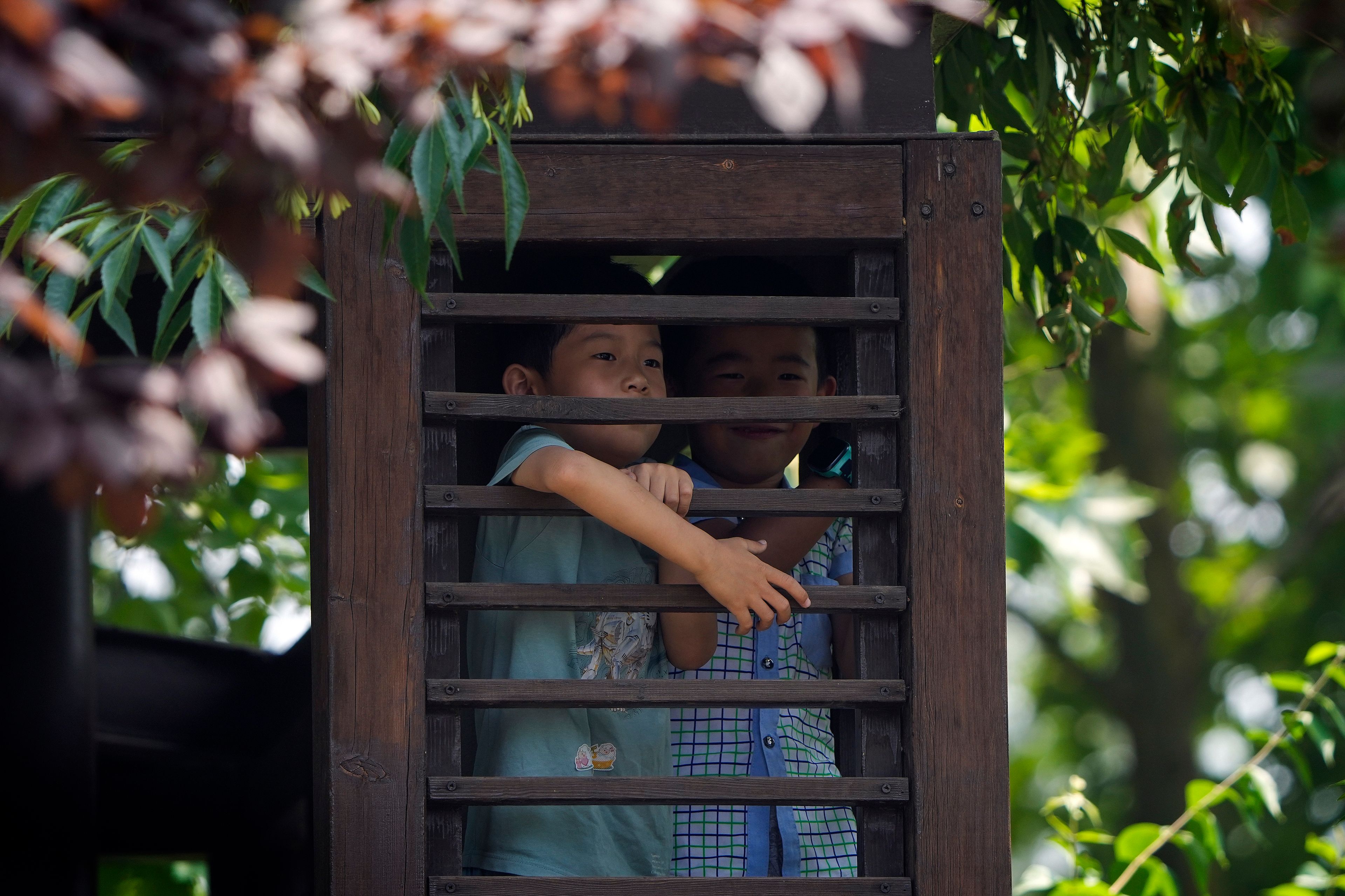 Children climb on a pavilion to watch the dragon boat races during the Dragon Boat Festival at a canal in Tongzhou, outskirts of Beijing, Monday, June 10, 2024. The Duanwu Festival, also known as the Dragon Boat Festival, falls on the fifth day of the fifth month of the Chinese lunar calendar and is marked by eating rice dumplings and racing dragon boats.