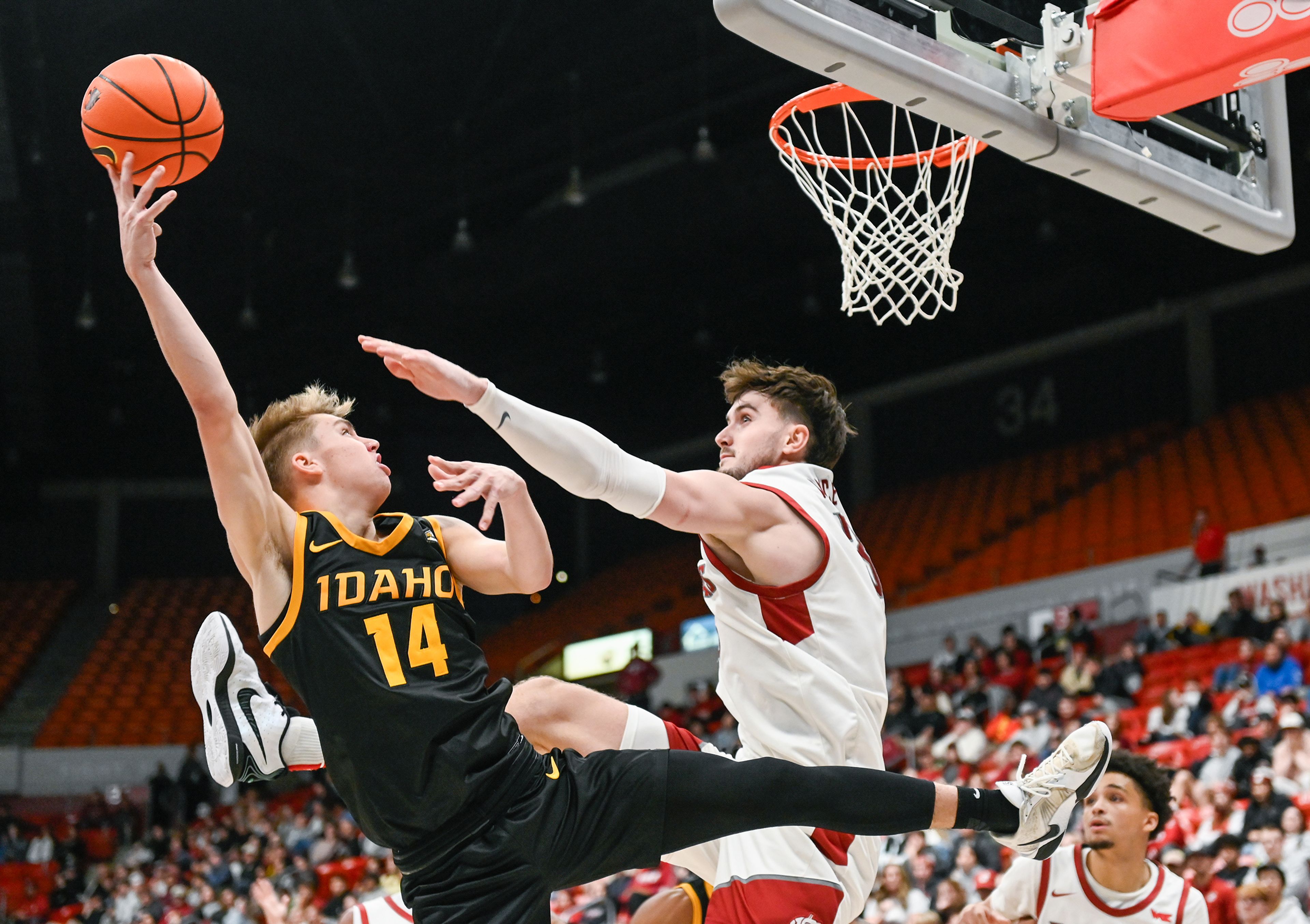 Idaho guard Kolton Mitchell and Washington State forward Ethan Price jump as Mitchell releases a two-point shot during the Battle of the Palouse game at Beasley Coliseum in Pullman.