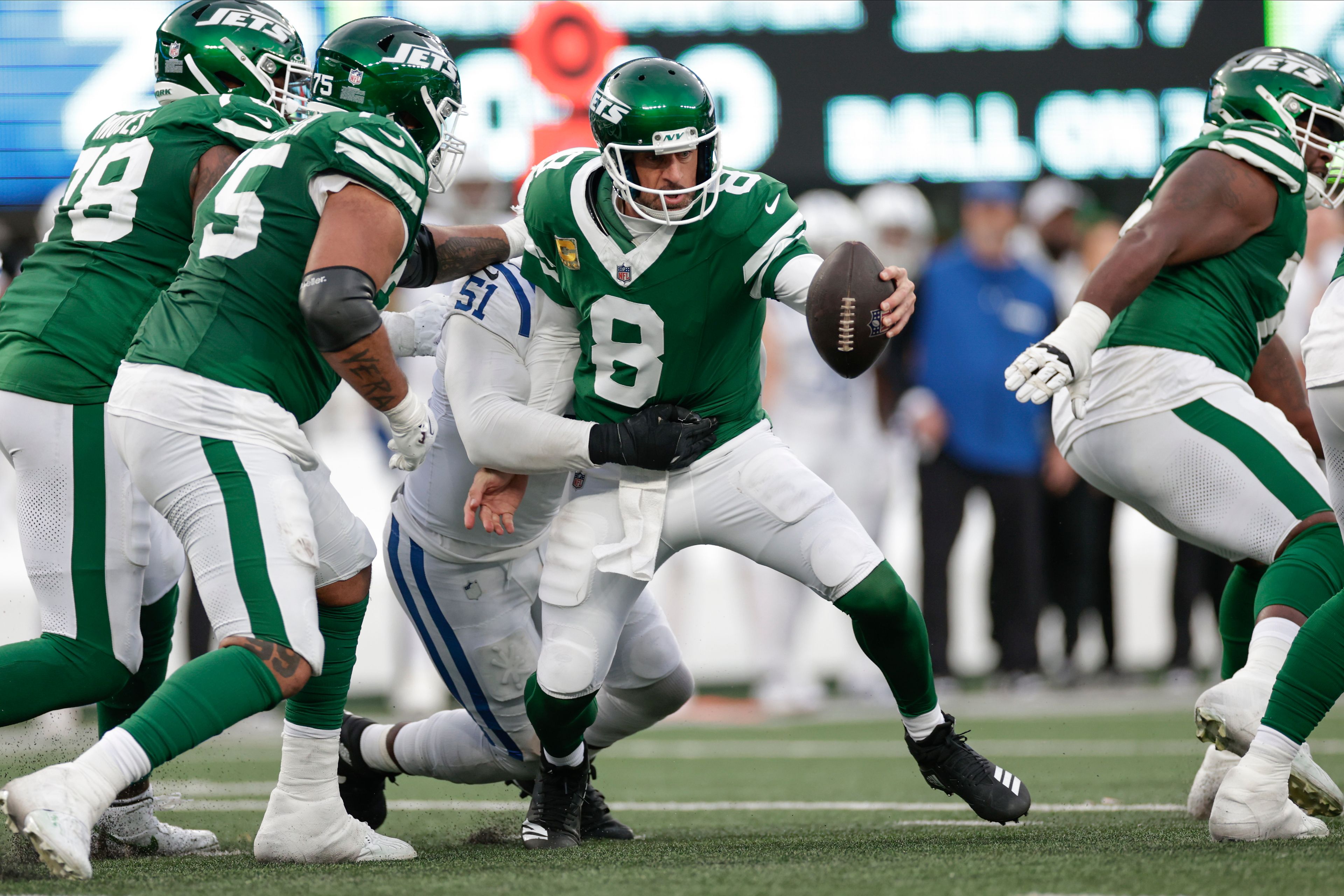 New York Jets quarterback Aaron Rodgers (8) tries to avoid a sack from Indianapolis Colts defensive end Kwity Paye (51) during the fourth quarter of an NFL football game, Sunday, Nov. 17, 2024, in East Rutherford, N.J. (AP Photo/Adam Hunger)