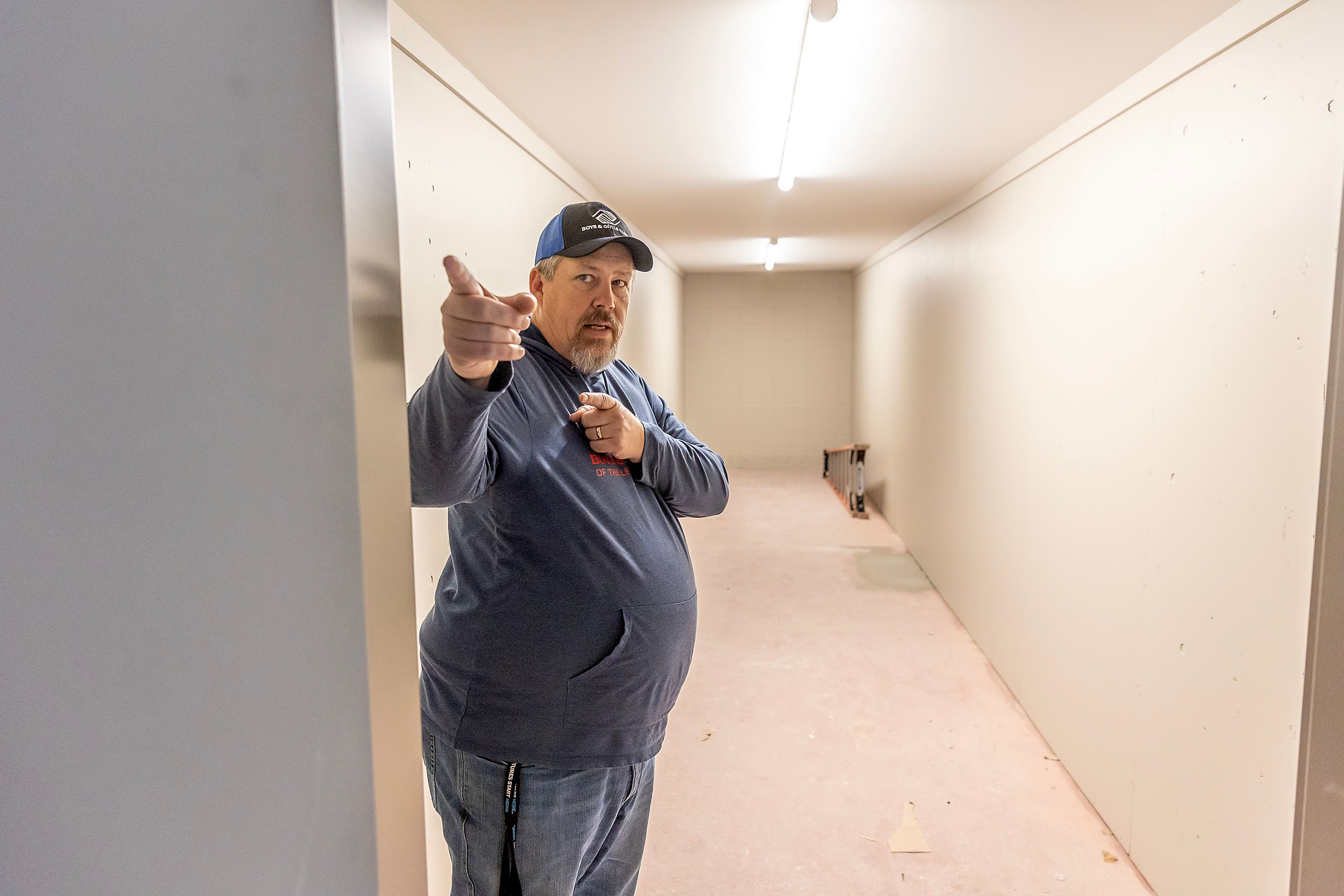 Jon Evans stands in a closet space that will be used to hold chairs and tables that can be wheeled out to the gym Wednesday in Lewiston.