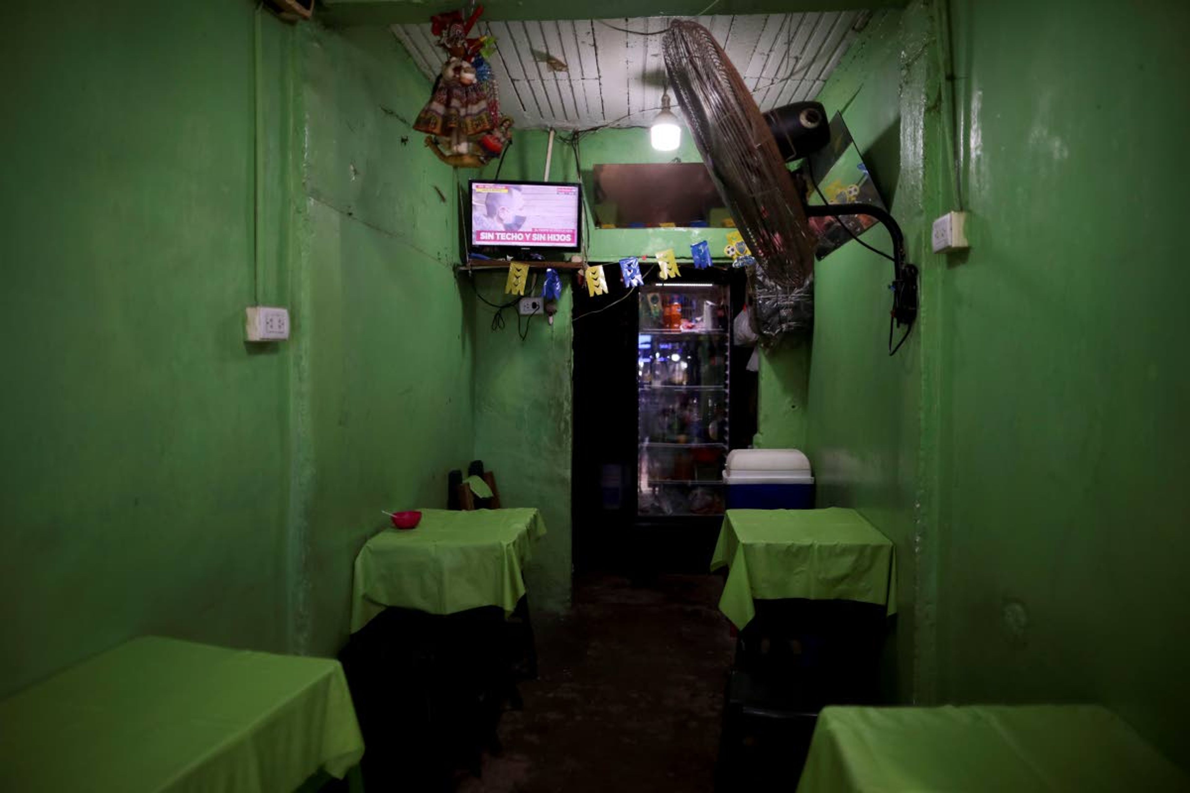 An empty restaurant in the "Villa 31" neighborhood is open for takeout during a government-ordered lockdown to curb the spread of the new coronavirus in Buenos Aires, Argentina, Wednesday, May 6, 2020. According to official data, the number of confirmed cases of COVID-19 in this slum have increased in the past week, putting authorities on high alert. (AP Photo/Natacha Pisarenko)