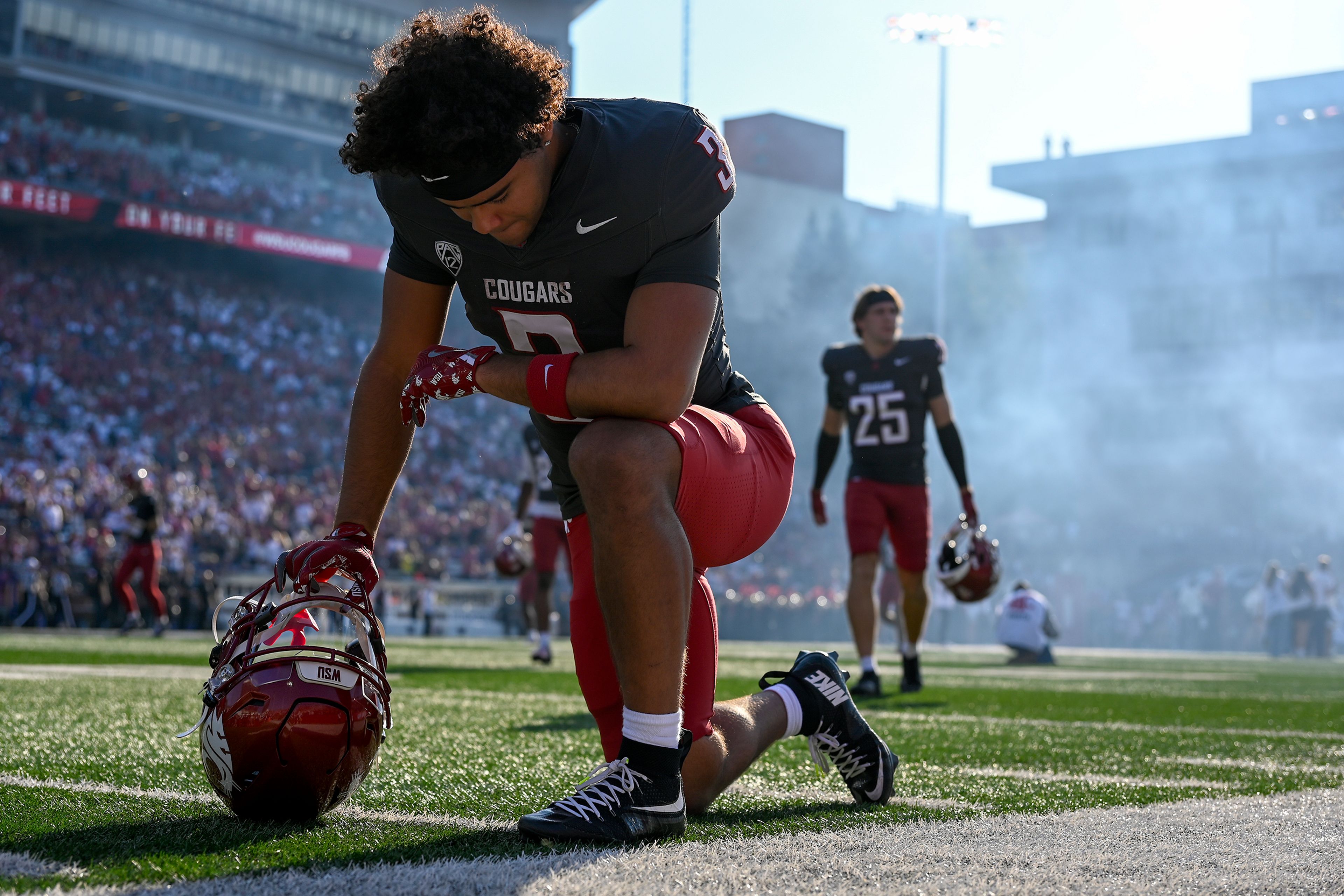 Washington State running back Maxwell Woods kneels after taking to the field during the Apple Cup on Saturday, Sept. 20, 2025, at Martin Stadium in Pullman, Wa.