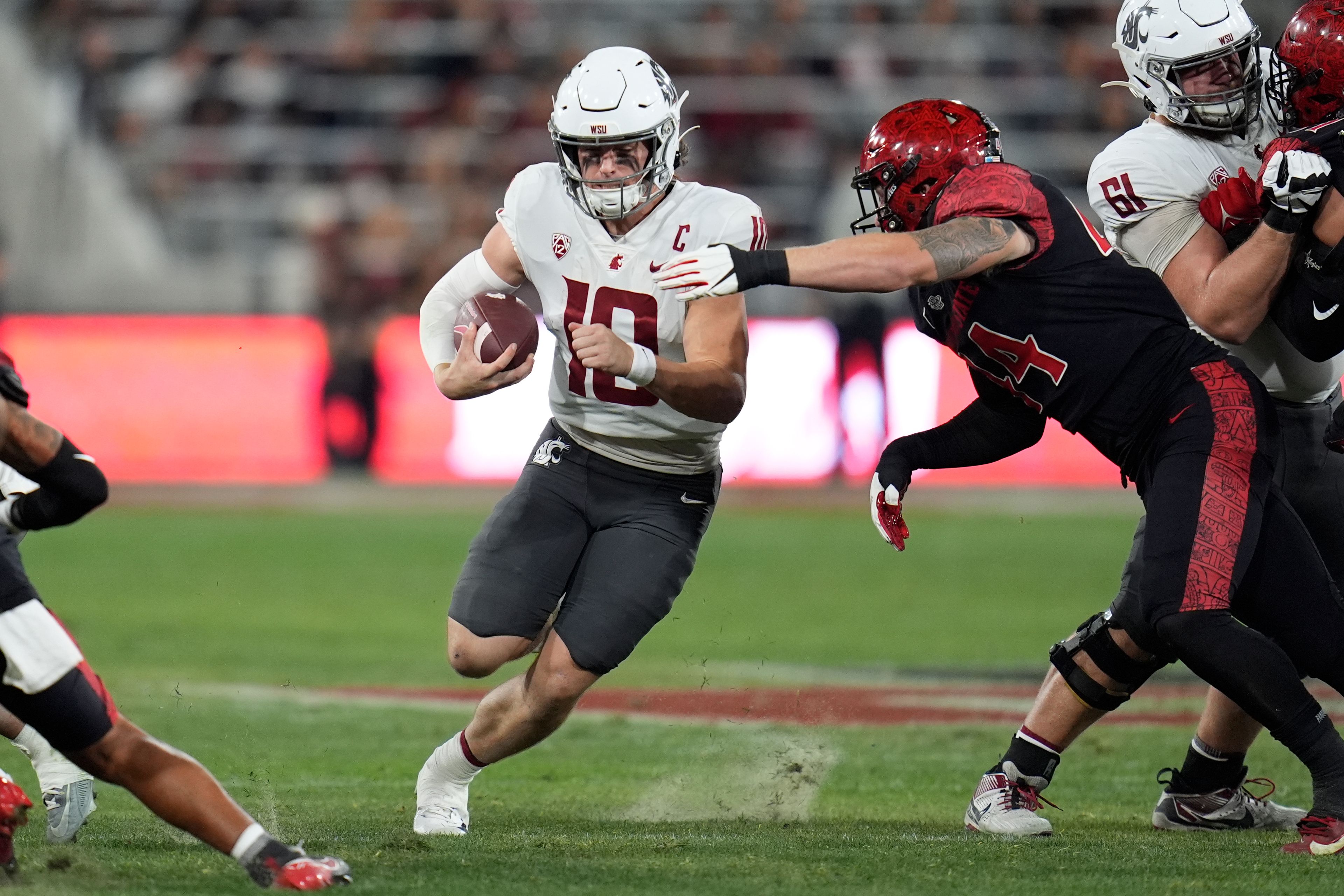 Washington State quarterback John Mateer runs with the ball during the first half of an NCAA college football game against San Diego State Saturday, Oct. 26, 2024, in San Diego. (AP Photo/Gregory Bull)