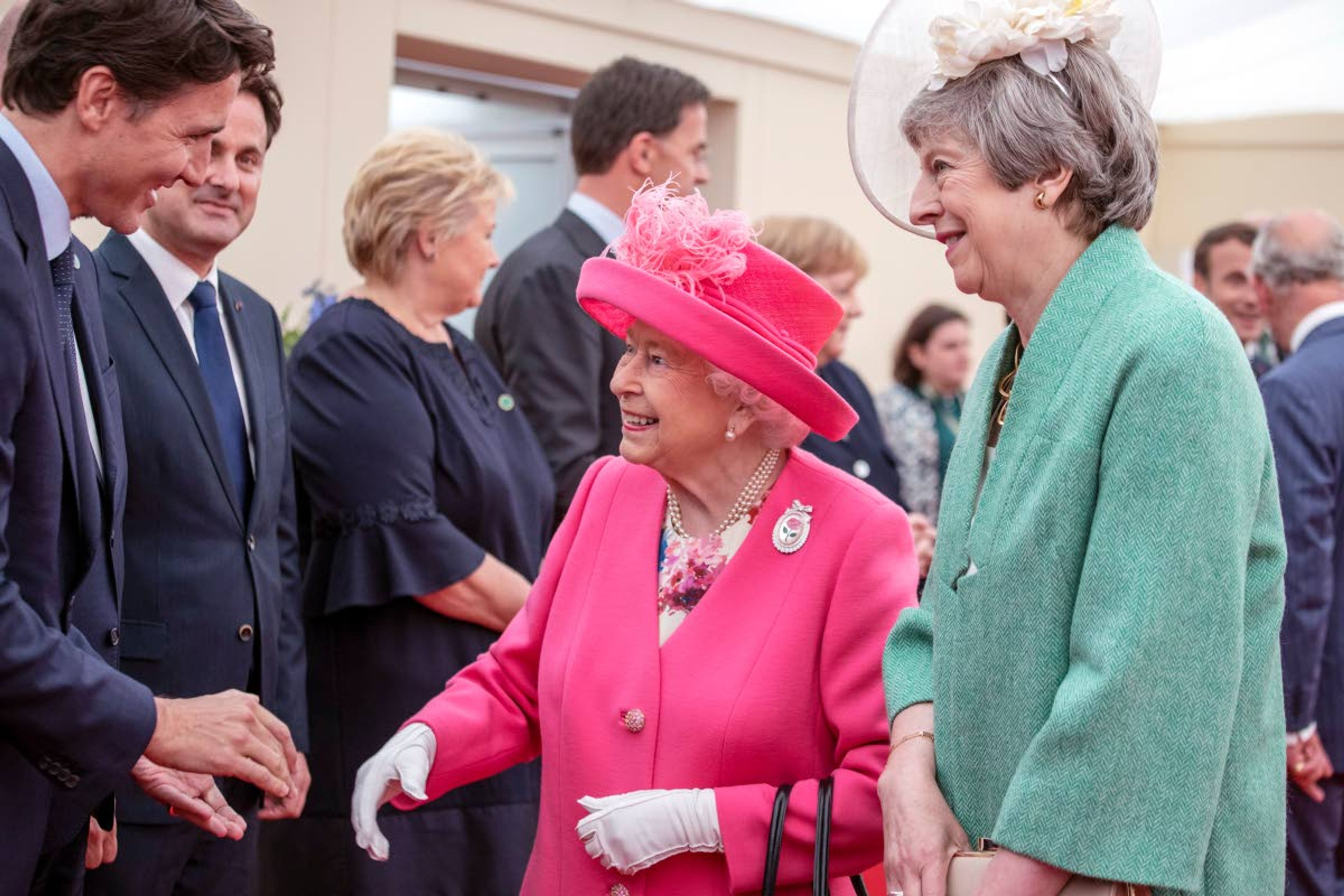 Britain's Queen Elizabeth II, accompanied by Prime Minister Theresa May meet with Canada Prime Minister Justin Trudeau, during a meeting of Allied national leaders during events are marking the 75th Anniversary of D-Day. Commemoration events are marking the 75th Anniversary of the D-Day landings when Allied forces stormed the beaches of Normandy in northern France during World War II.(Jack Hill/Pool via AP)