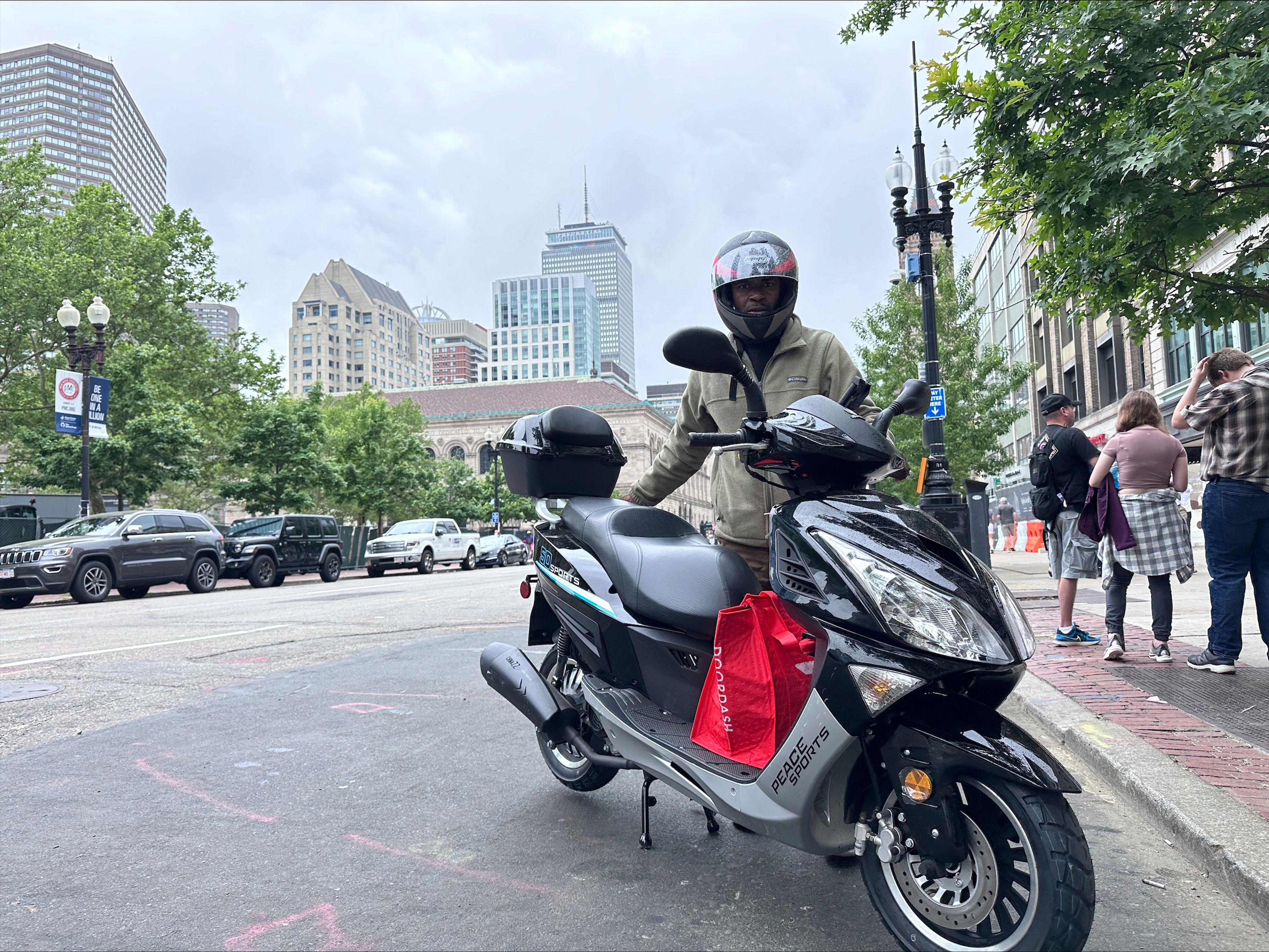 Delivery scooters are parked as drivers wait to pick up food for delivery, Thursday, June 6, 2024, in Boston. Boston and New York are cracking down on unlawful drivers, whom they say are ignoring traffic laws and making city streets more dangerous.