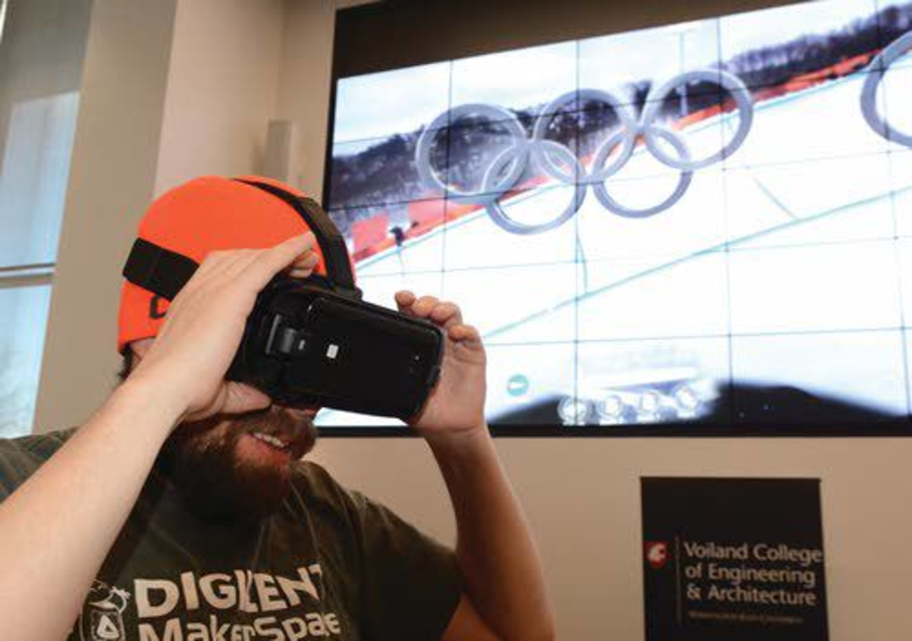 Washington State University research operations engineer Scott Hanson watches the Olympics via virtual reality technology Wednesday in the atrium of the Spark Building on the WSU campus in Pullman.