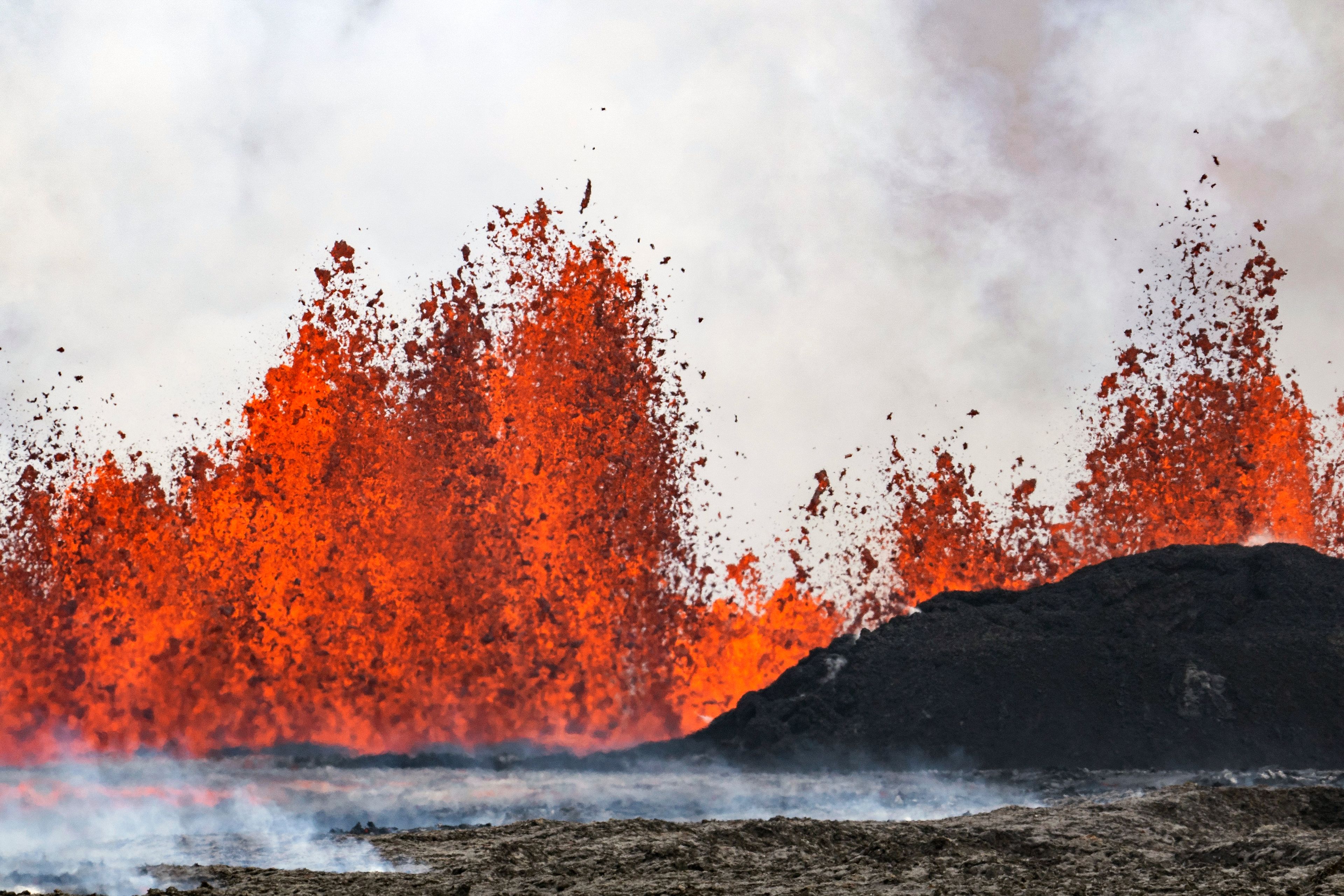 A volcano spews lava in Grindavik, Iceland, Wednesday, May 29, 2024. A volcano in southwestern Iceland is erupting, spewing red streams of lava in its latest display of nature's power. A series of earthquakes before the eruption Wednesday triggered the evacuation of the popular Blue Lagoon geothermal spa. The eruption began in the early afternoon north of Grindavik, a coastal town of 3,800 people that was also evacuated.