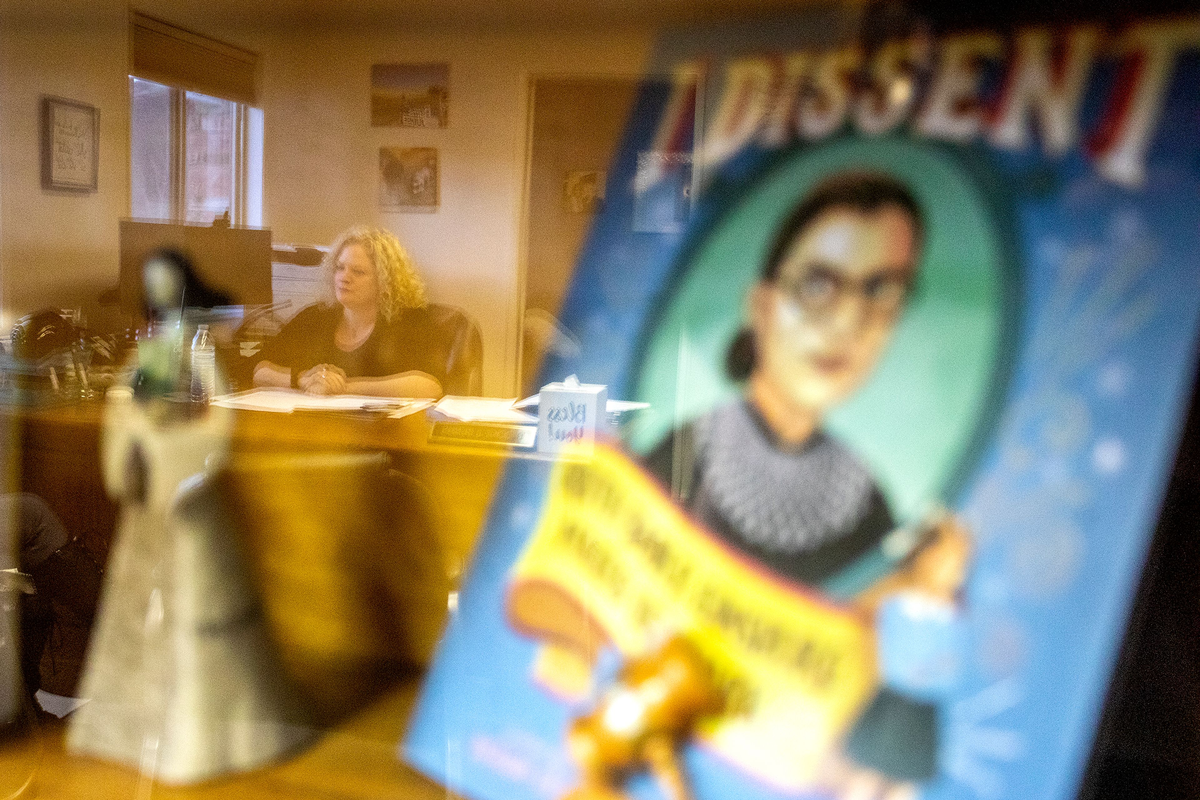 Judge Brooke Burns is reflected in glass where the book “I dissent: Ruth Bader Ginsburg Makes Her Mark” sits at her office in the Asotin County Courthouse on Thursday.