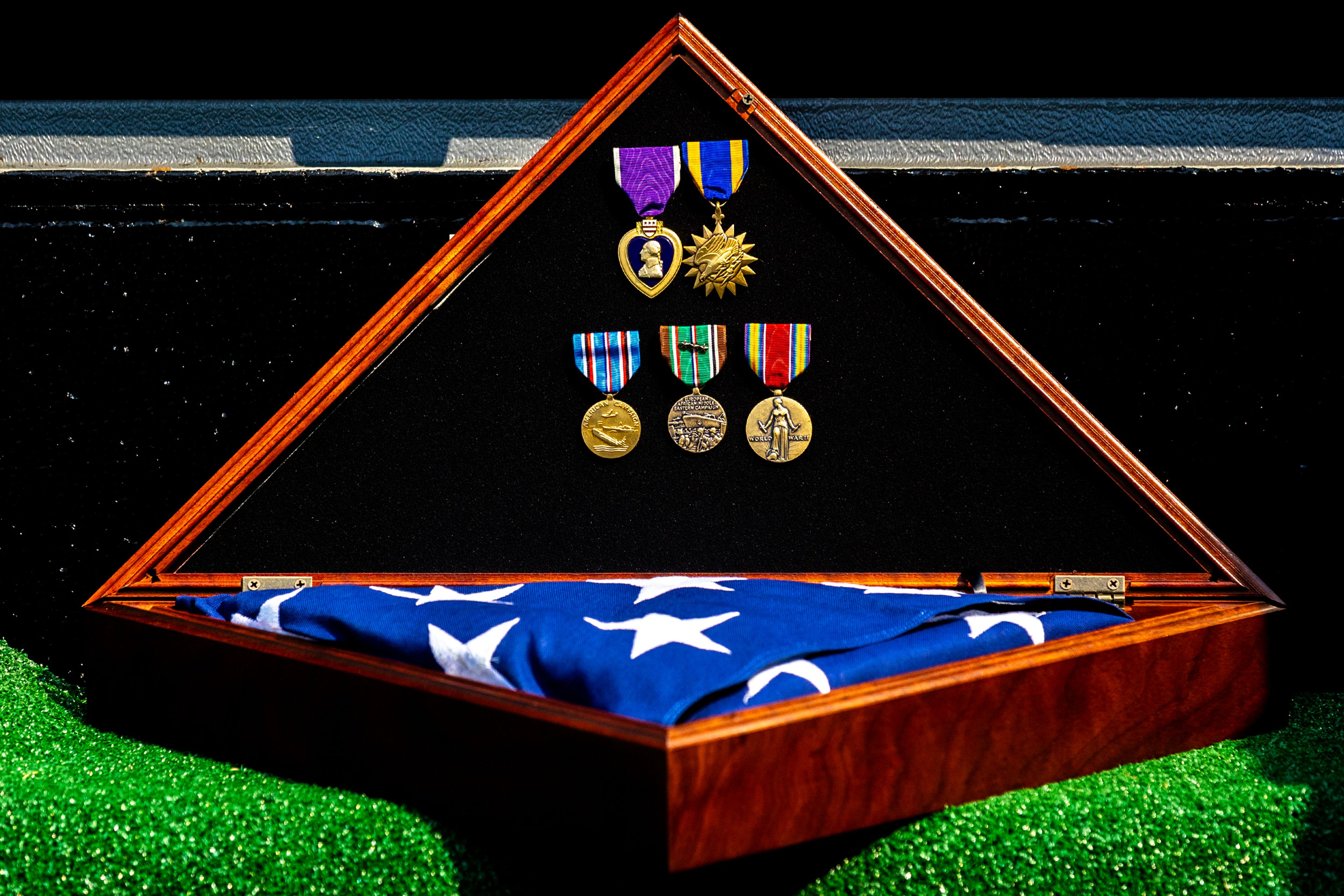 Military medals lay in front of Allan Knepper’s casket Thursday at the Normal Hill Cemetery in Lewiston.