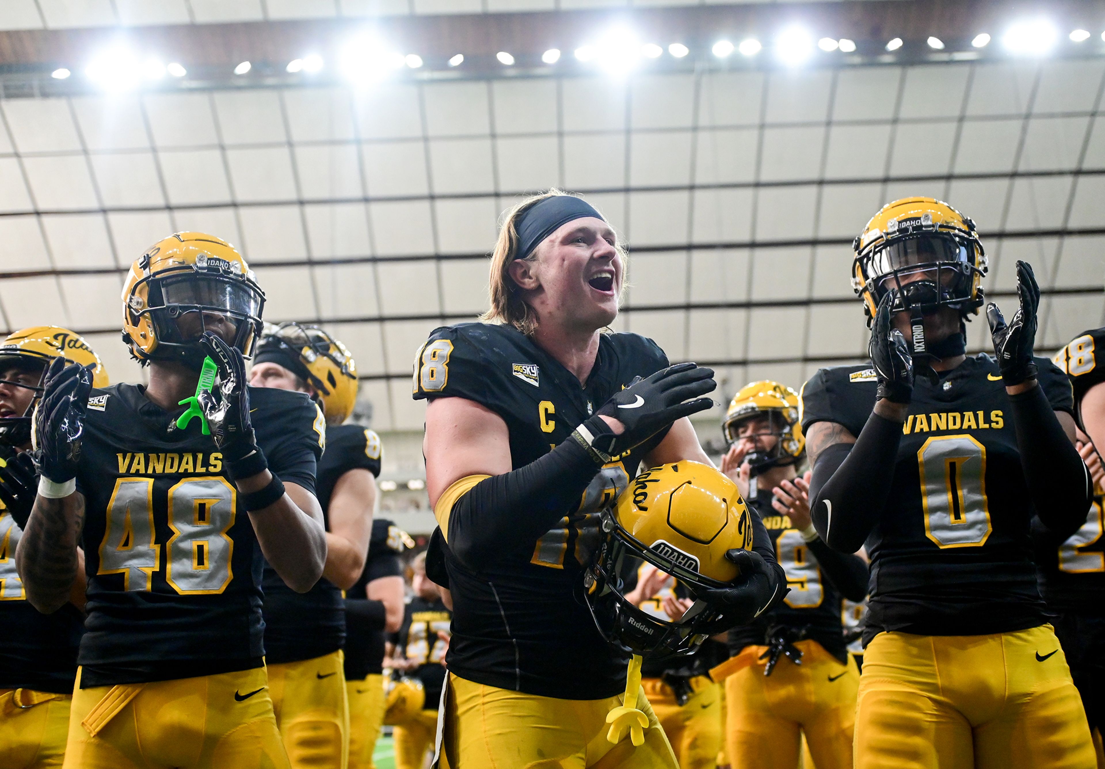 Idaho players celebrate their win over Northern Arizona Saturday at the P1FCU Kibbie Dome in Moscow.,