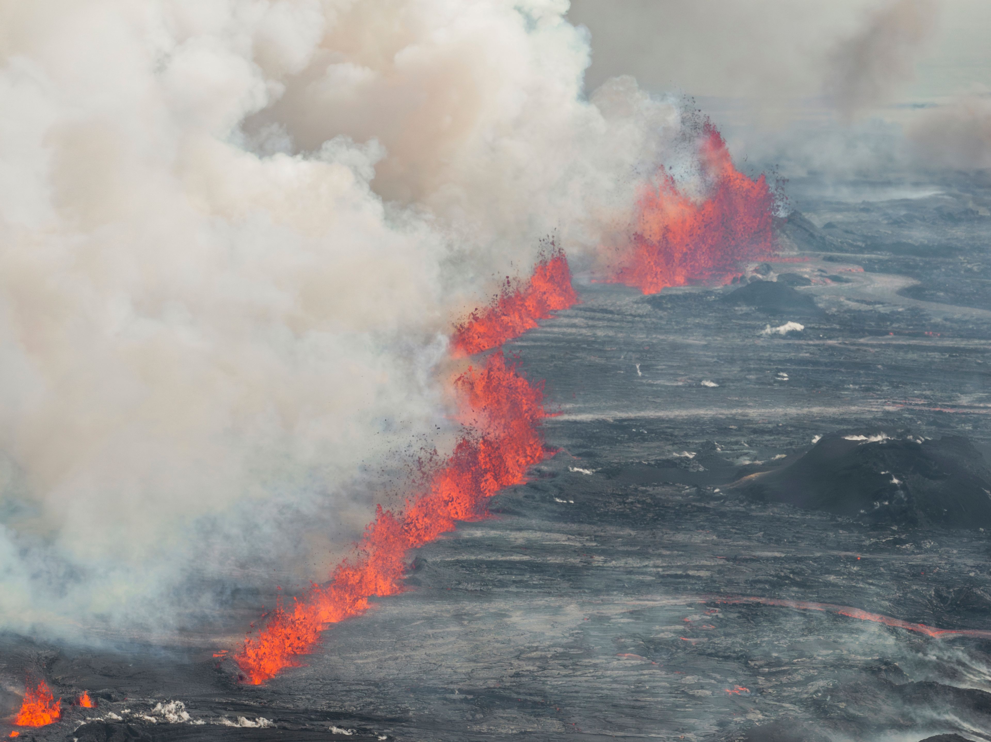 An eruptive fissure spews lava and smoke from a volcano in Grindavik, Iceland, Wednesday, May 29, 2024. A volcano in southwestern Iceland erupted Wednesday for the fifth time since December, spewing red lava that once again threatened the coastal town of Grindavik and led to the evacuation of the popular Blue Lagoon geothermal spa.