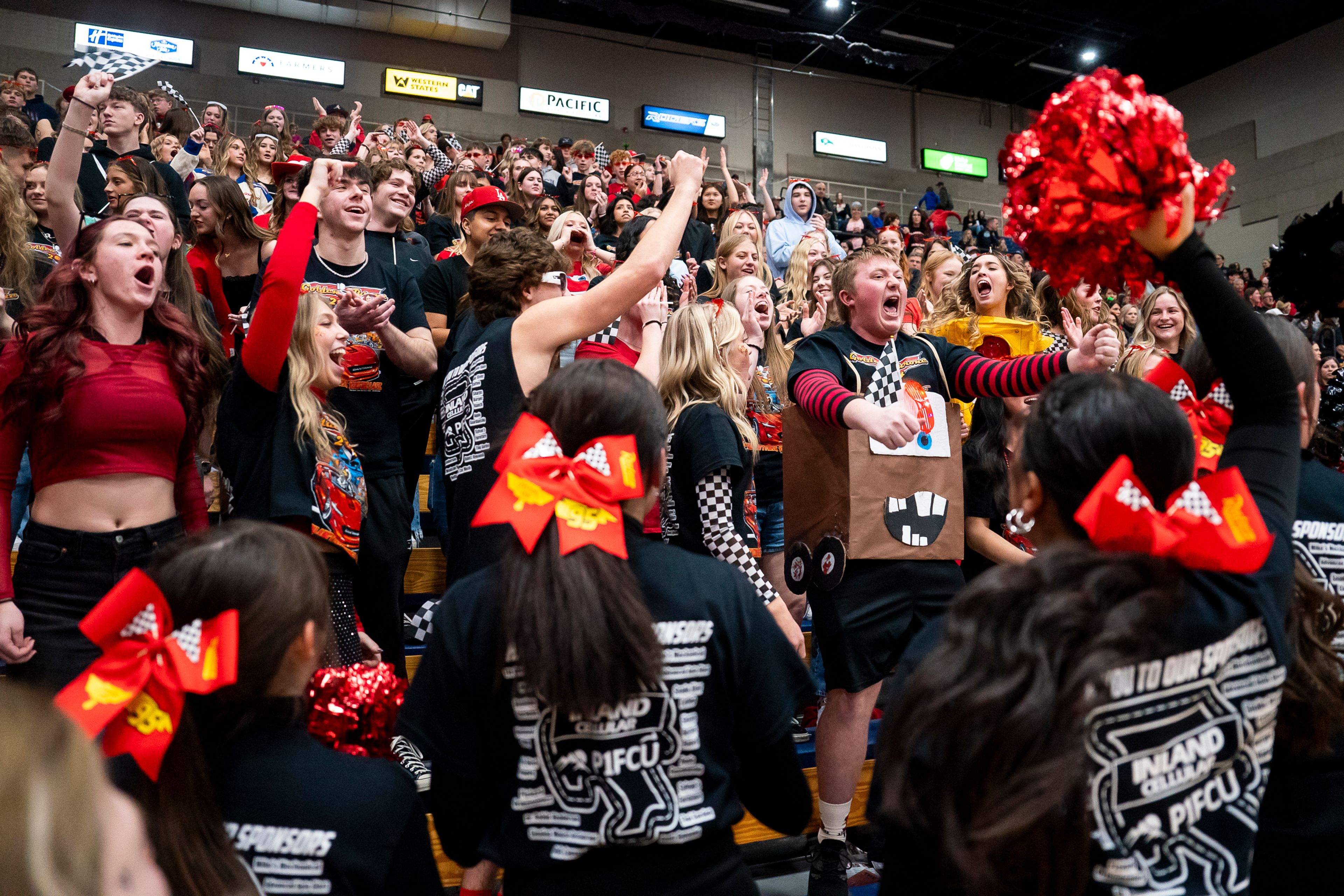 The Clarkston High School student section cheer as their girls basketball team takes the court for their Golden Throne rivalry game against Lewiston on Friday inside the P1FCU Activity Center in Lewiston.