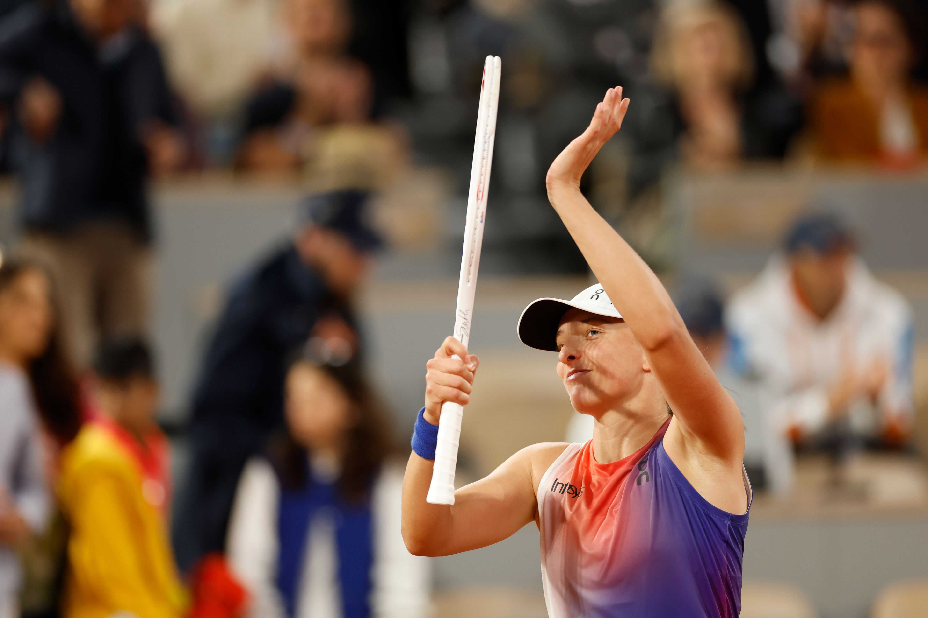 Poland's Iga Swiatek celebrates as she won her first round match against France's Leolia Jeanjean at the French Open tennis tournament, at the Roland Garros stadium in Paris, Monday, May 27, 2024.