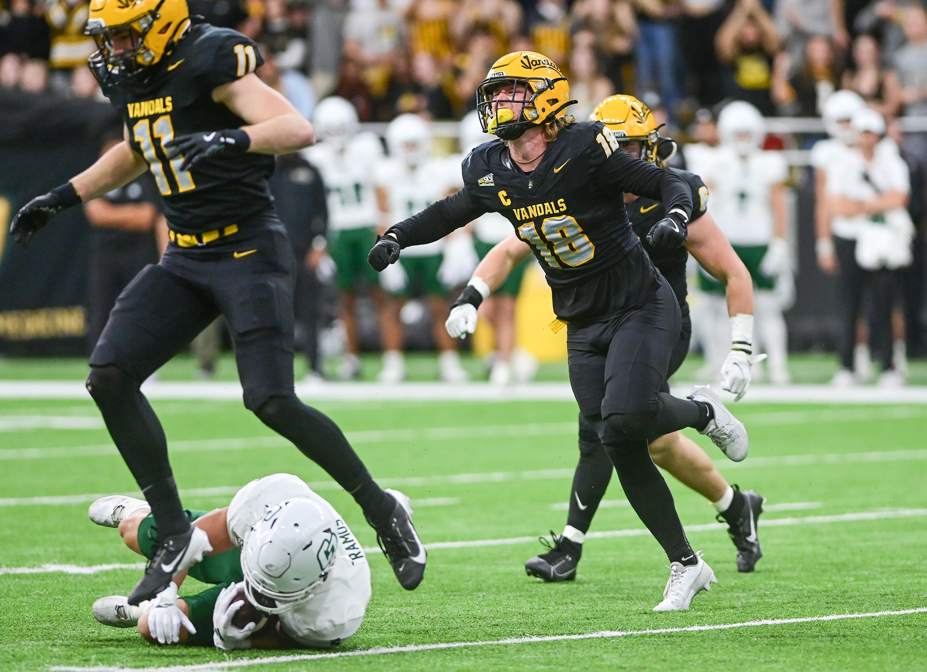 Idaho defensive back Tommy McCormick celebrates Cal Poly running back Aiden Ramos being tackled Saturday at the P1FCU Kibbie Dome in Moscow.,