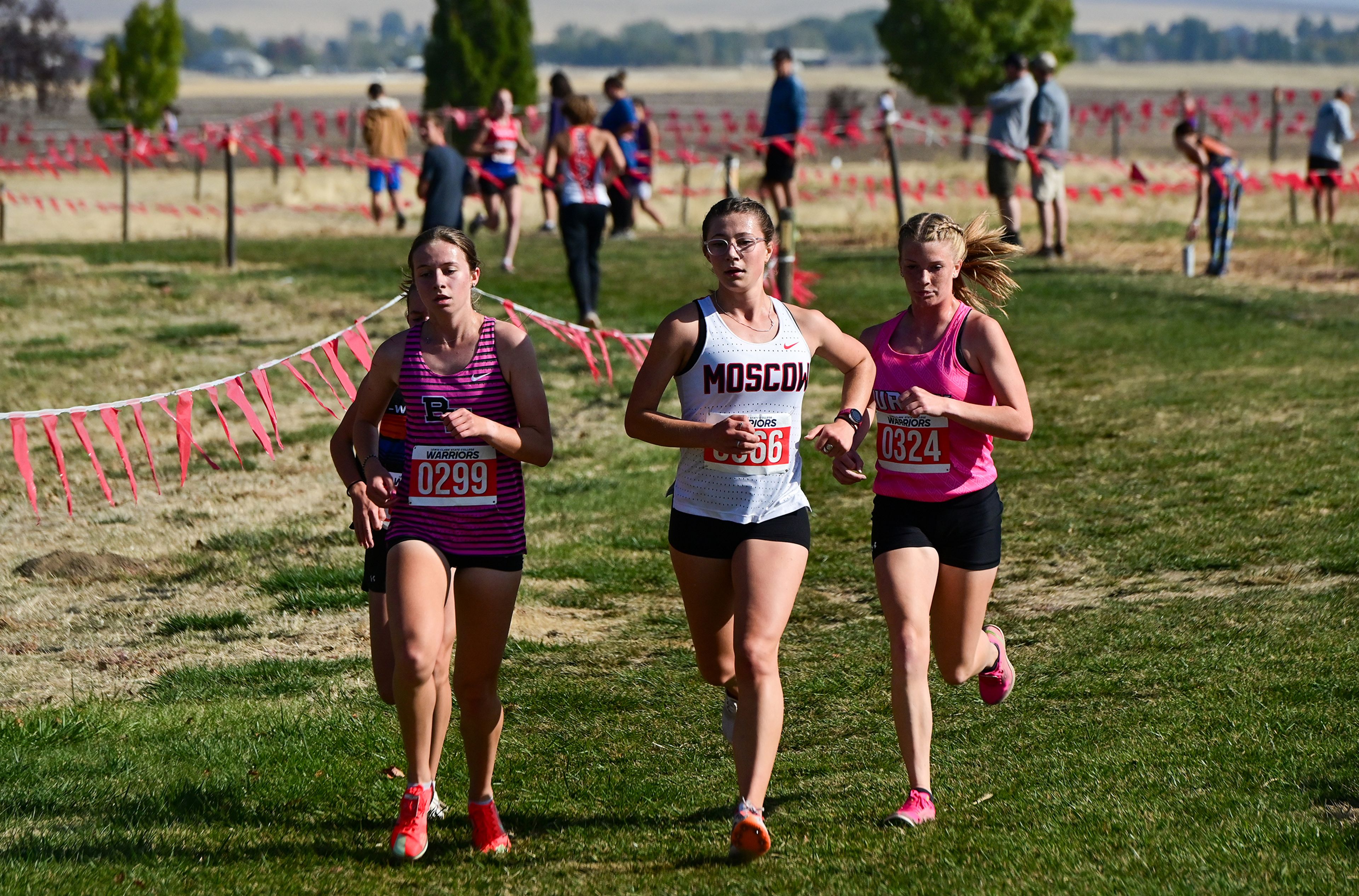 Moscow's Cora Crawford runs in the leading pack of girls in the Inland Empire Championships varsity girls 5K Saturday along the LCSC XC Course in Lewiston.,