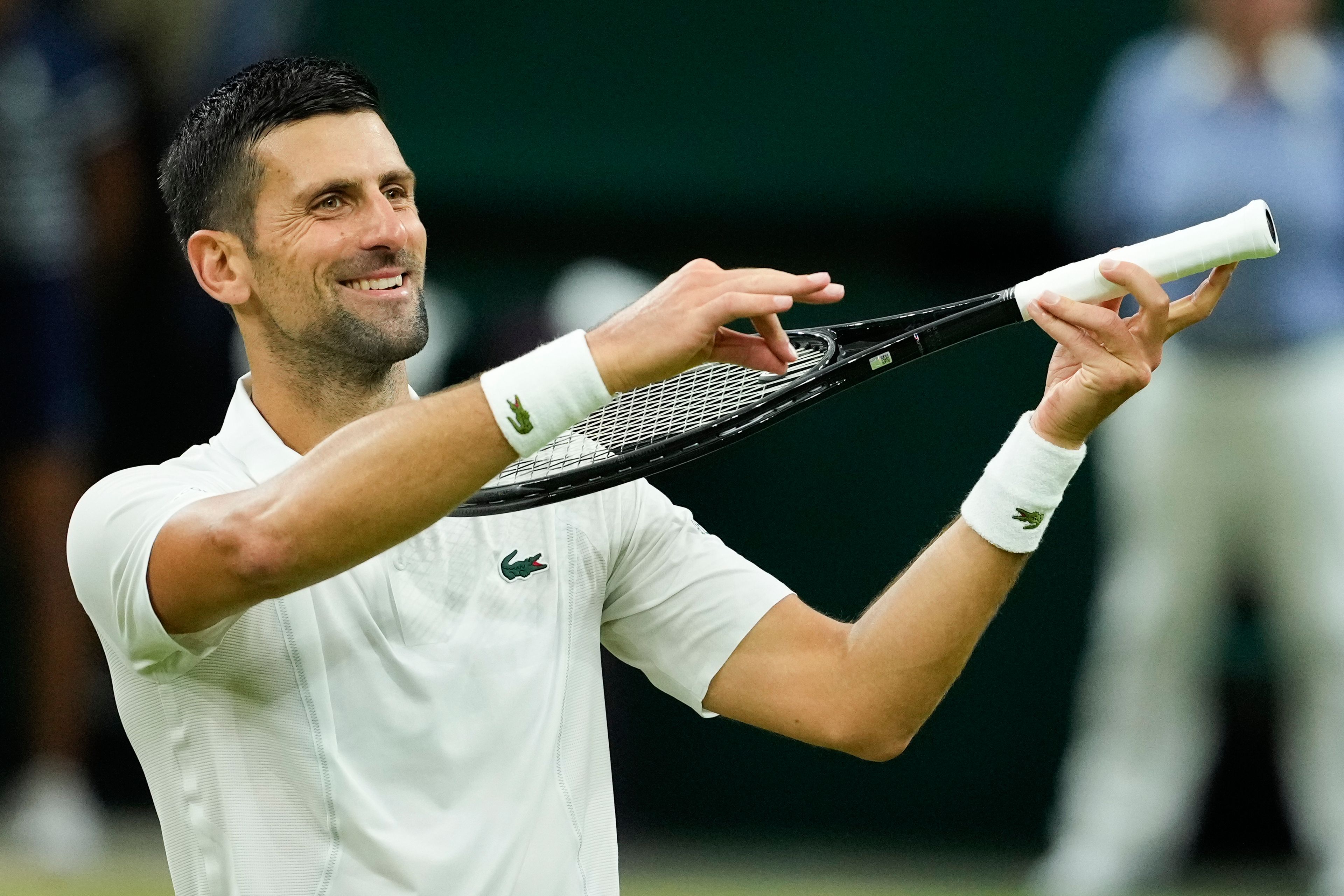 Novak Djokovic of Serbia celebrates after defeating Holger Rune of Denmark in their fourth round match at the Wimbledon tennis championships in London, Monday, July 8, 2024. (AP Photo/Mosa'ab Elshamy)