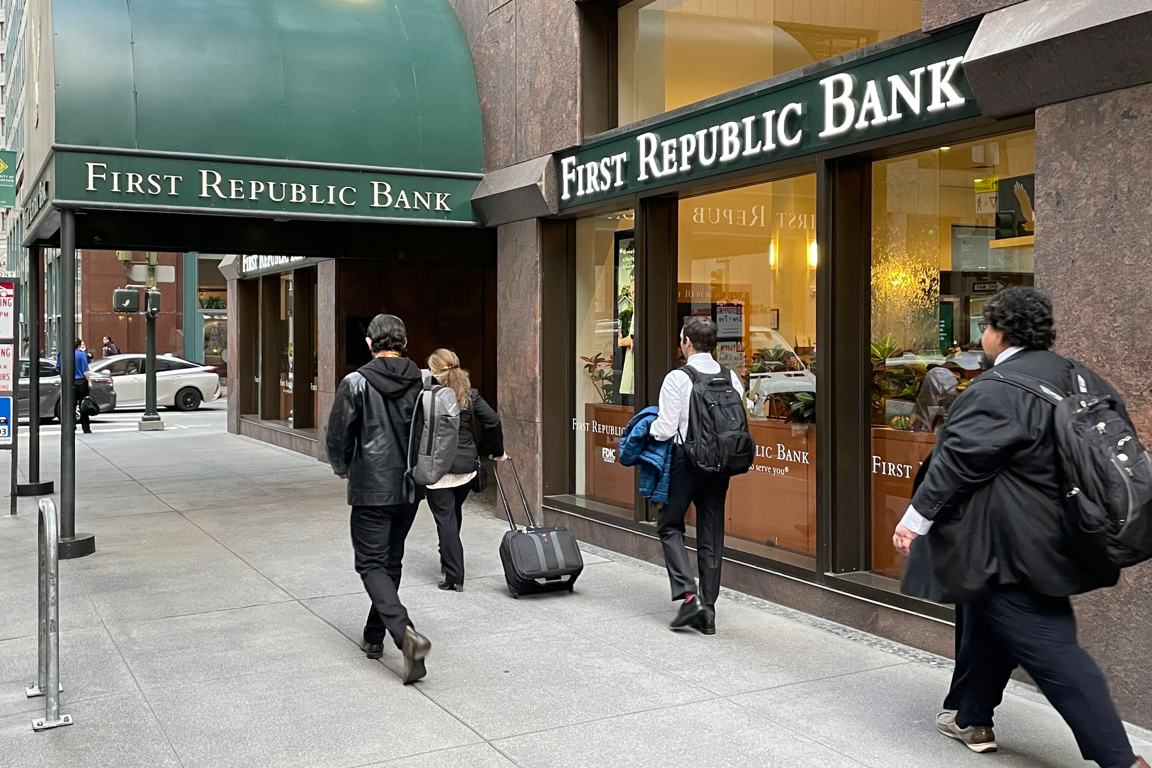 People walk past the headquarters of First Republic Bank in San Francisco, Monday.