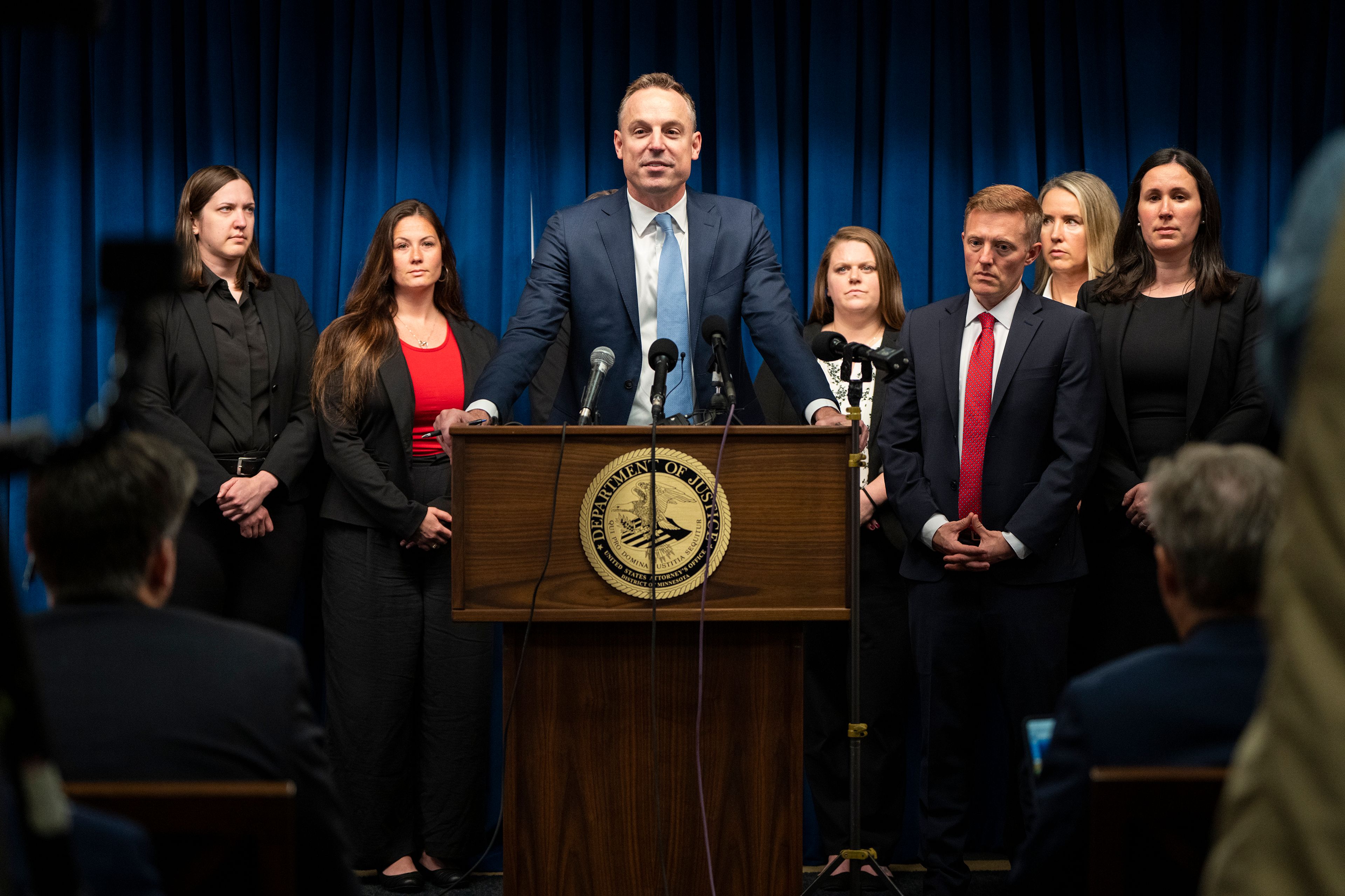 Assistant U.S. Attorney Joe Thompson, surrounded by the prosecution's trial team, speaks during a news conference after the verdict was read in the first Feeding Our Future case at the federal courthouse in Minneapolis, Friday, June 7, 2024. A jury convicted five Minnesota residents and acquitted two others Friday for their roles in a scheme to steal more than $40 million that was supposed to feed children during the coronavirus pandemic.