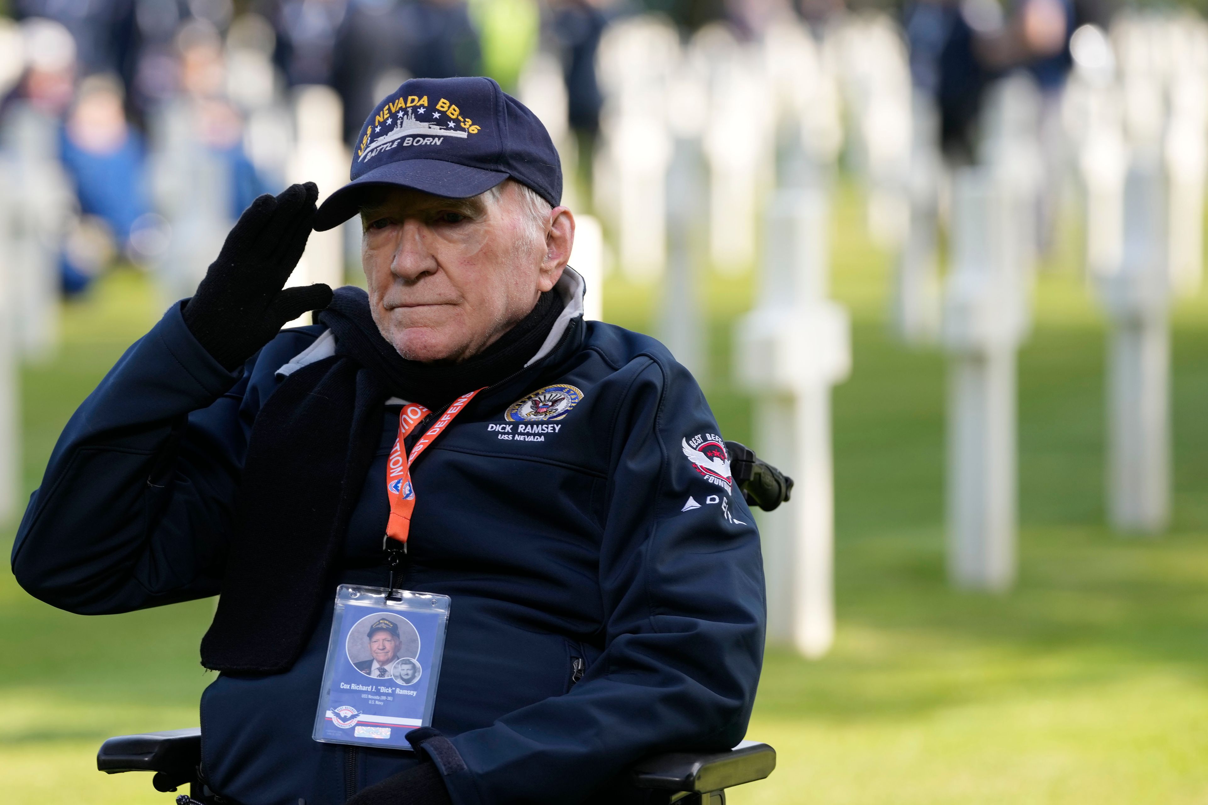 World War II and D-Day veteran Richard Ramsey salutes as he visits graves at the Normandy American Cemetery in Colleville-sur-Mer, Tuesday, June 4, 2024. World War II veterans from across the United States as well as Britain and Canada are in Normandy this week to mark 80 years since the D-Day landings that helped lead to Hitler's defeat. (AP Photo/Virginia Mayo)