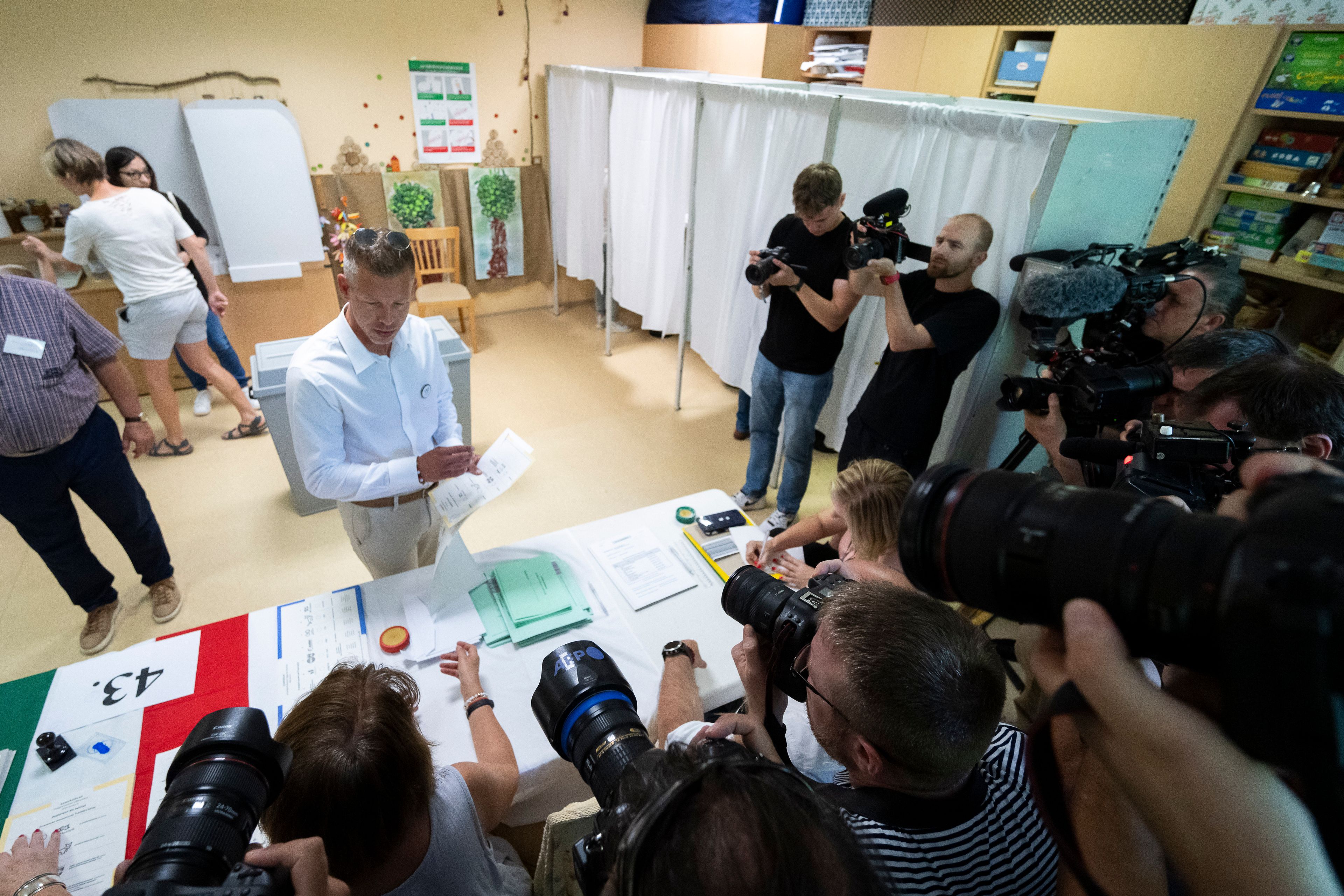 Political newcomer Péter Magyar receives his ballot papers at a polling station during European Parliamentary elections in Budapest, Hungary, Sunday, June 9, 2024. Polling stations have opened across Europe as voters from 20 countries cast ballots in elections that are expected to shift the European Union’s parliament to the right and could reshape the future direction of the world’s biggest trading bloc.