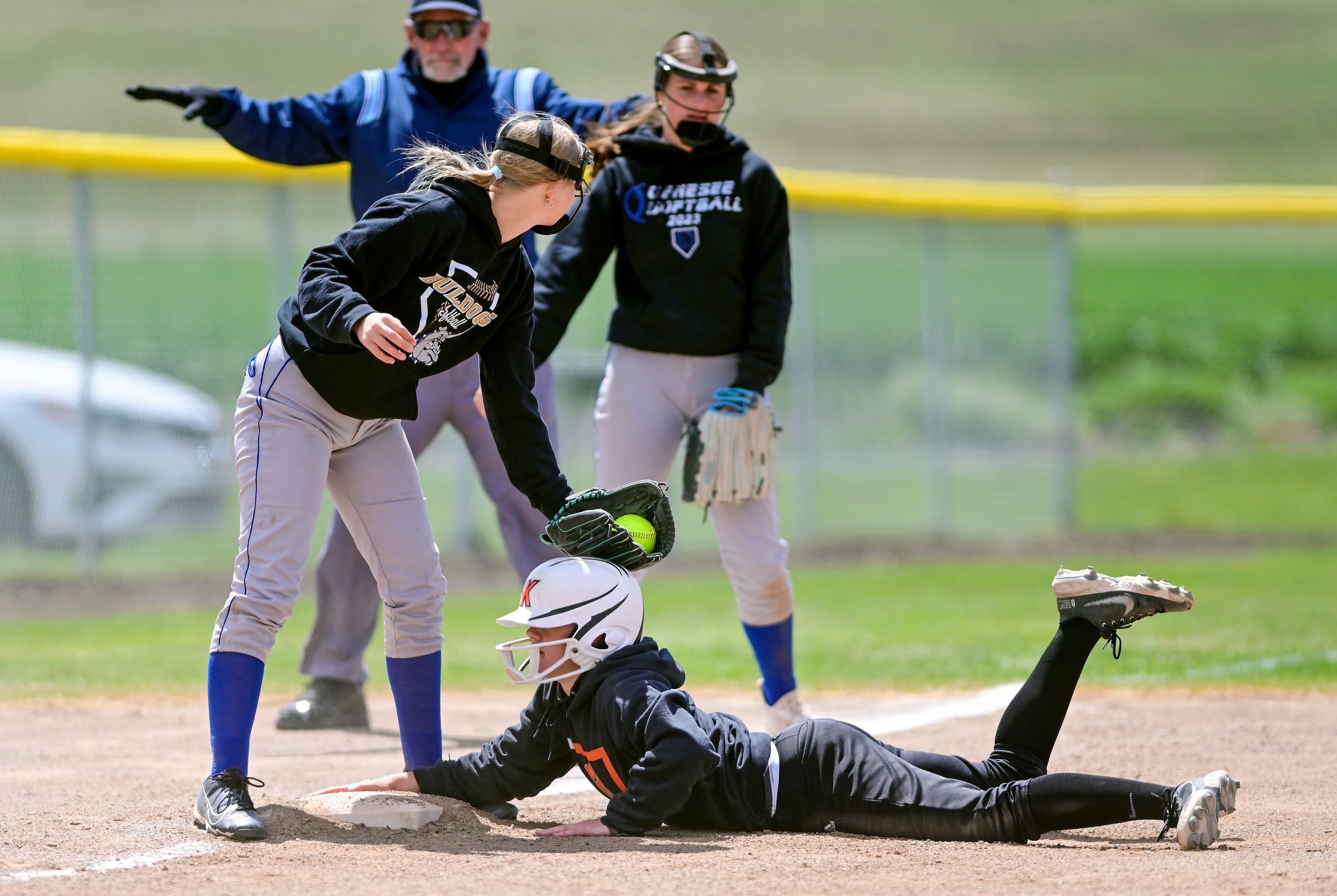 Genesee’s Sydney Banks, left, looks for a call from an umpire while attempting to tag out Kendrick’s Hailey Taylor, who made it safely to third base, during an Idaho Class 1A state championship game Friday in Genesee.