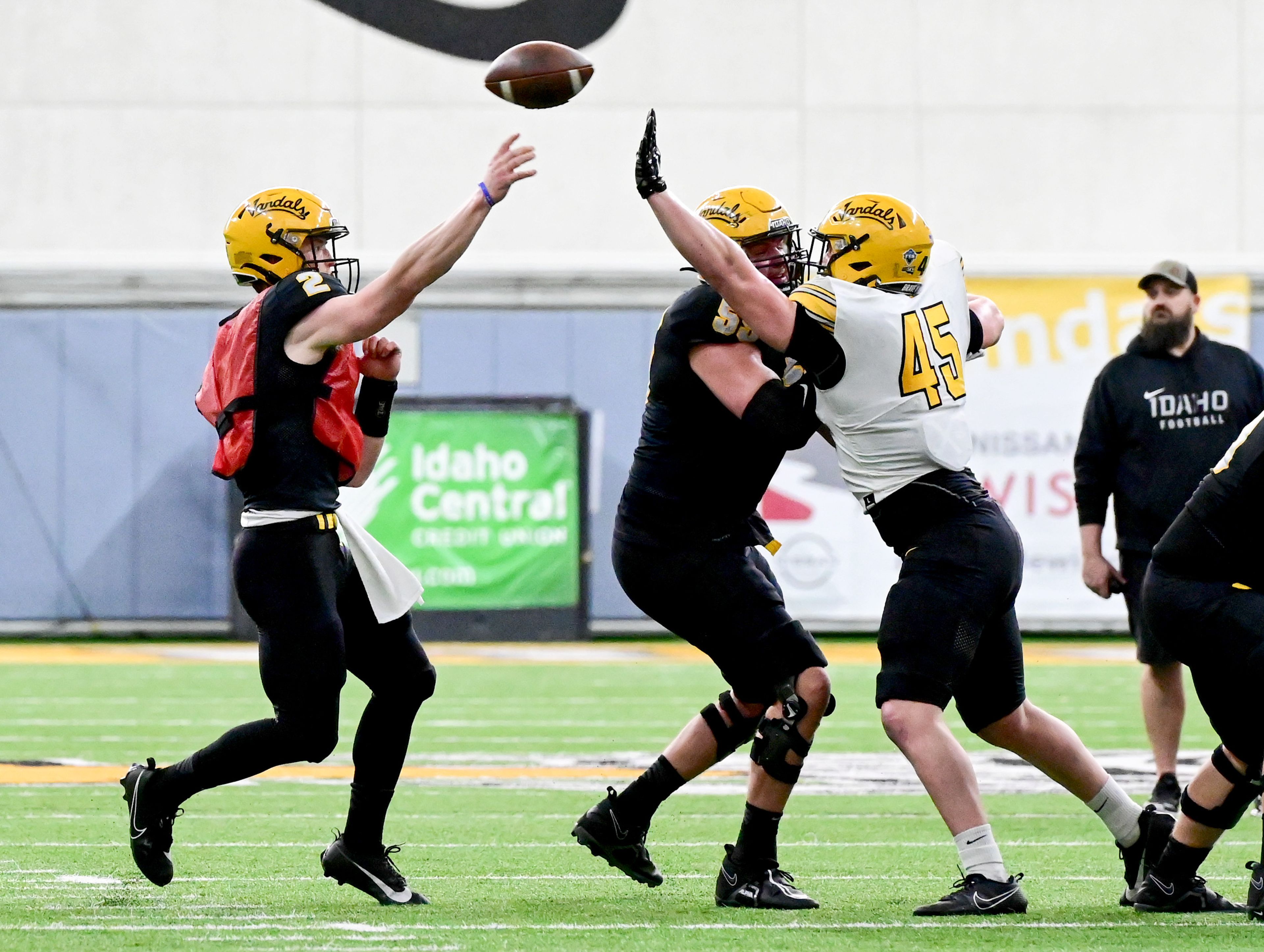 A pass by Vandals quarterback Jack Layne, left, moves past an attempted block by tight end Mitchel Jaskowiak (45) during the annual spring game April 26 at the P1FCU Kibbie Dome in Moscow.