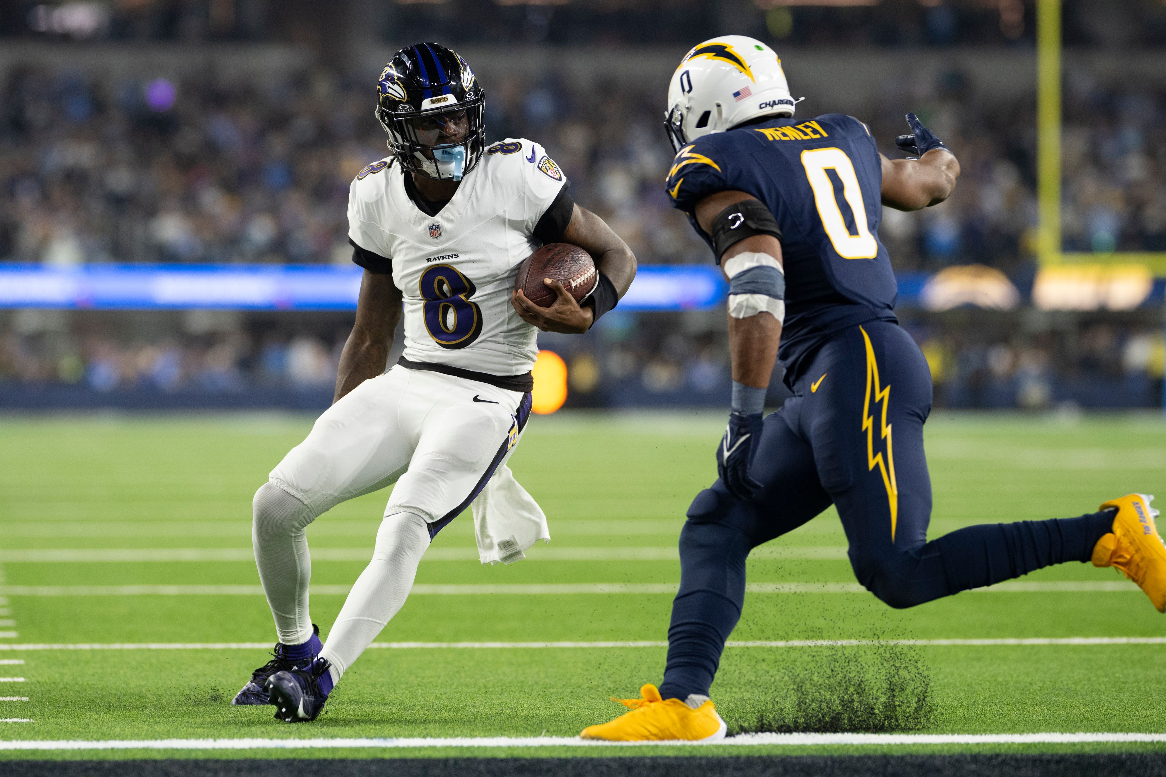 Baltimore Ravens quarterback Lamar Jackson (8) runs with the ball as Los Angeles Chargers linebacker Daiyan Henley (0) chases during an NFL football game, Monday, Nov. 25, 2024, in Inglewood, Calif. (AP Photo/Kyusung Gong)