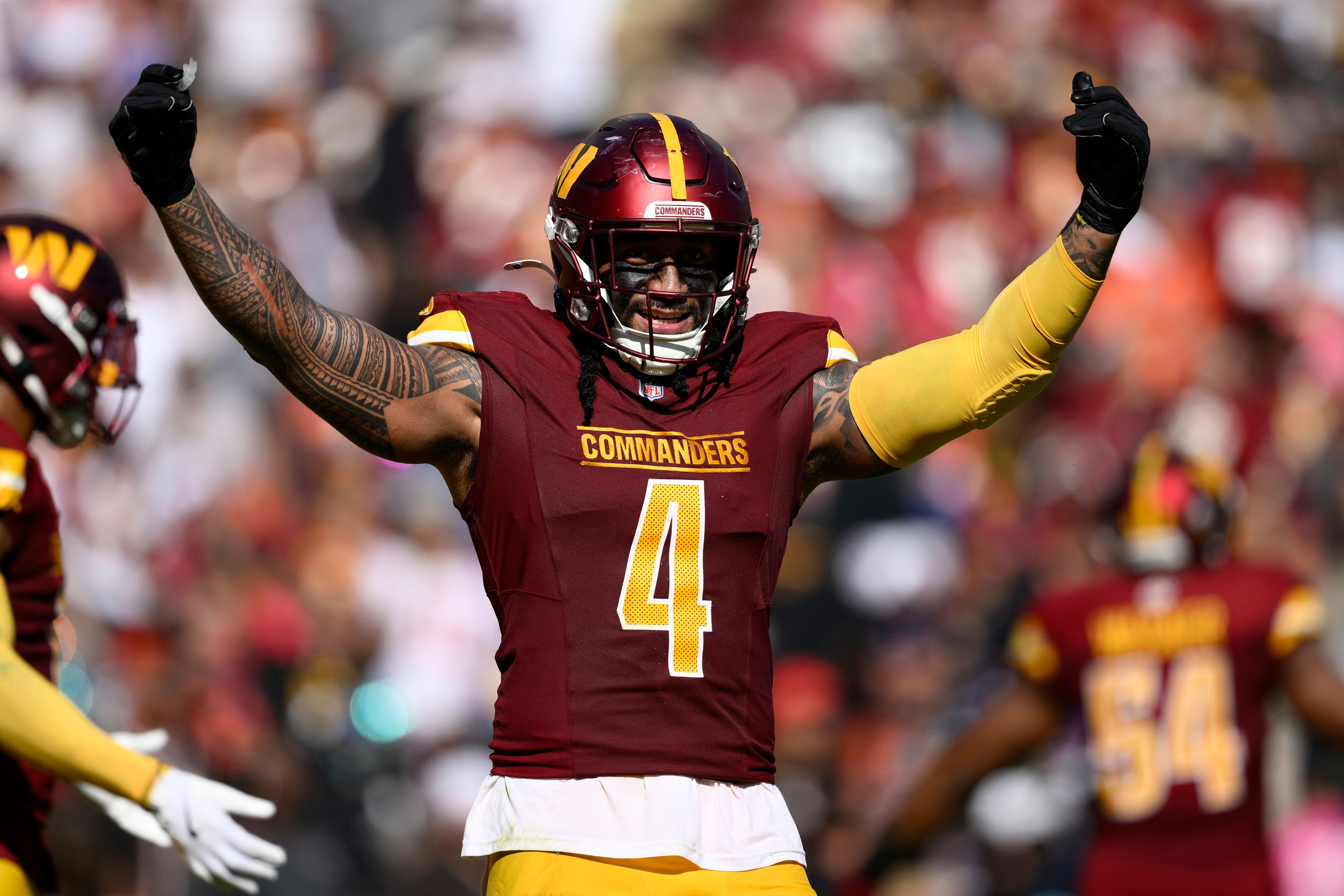 Washington Commanders linebacker Frankie Luvu (4) fires up the crowd during the second half of an NFL football game against the Cleveland Browns in Landover, Md., Sunday, Oct. 6, 2024. (AP Photo/Nick Wass)