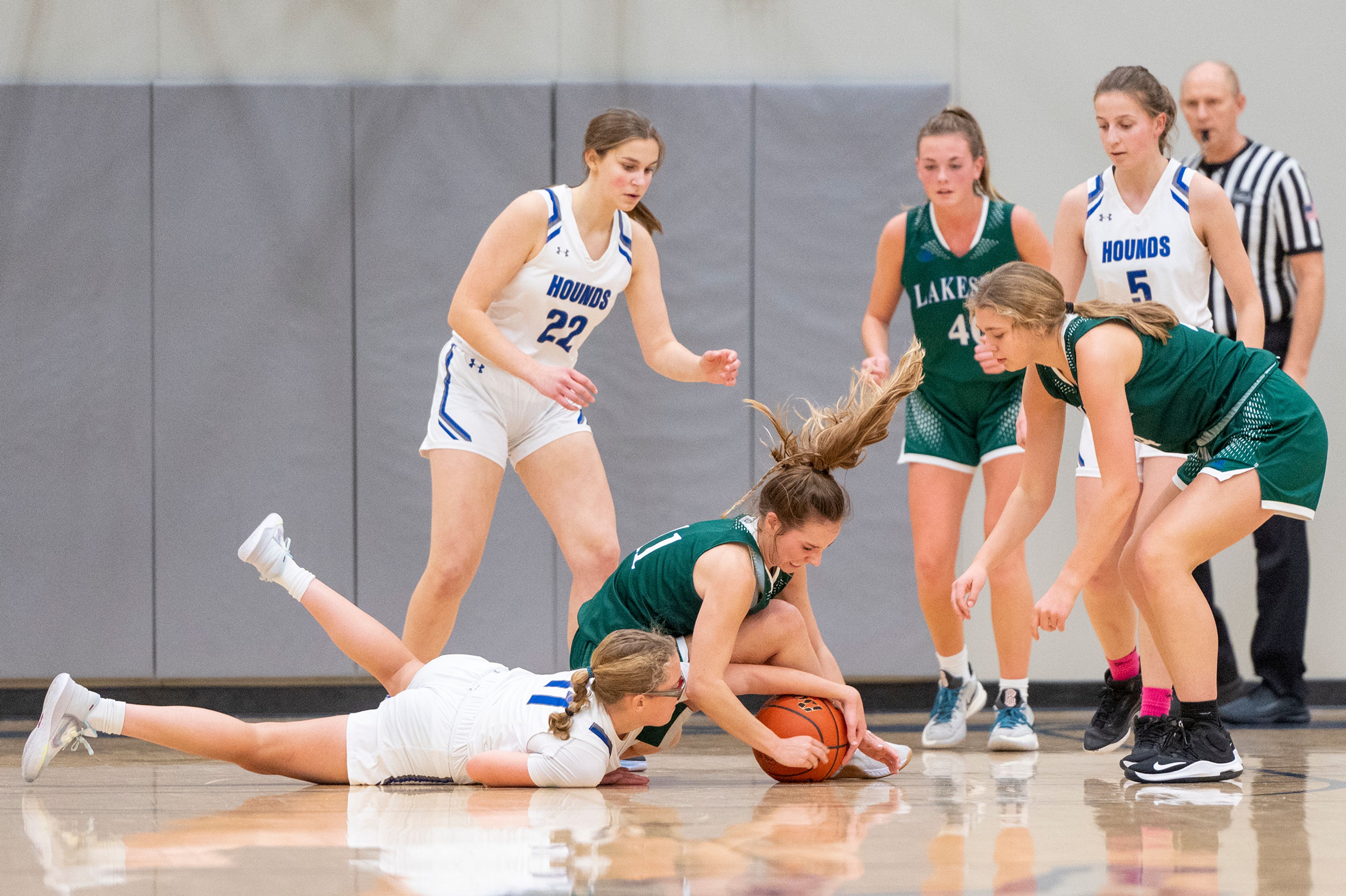 Pullman guard Lil Cobos, on ground, fights for a loose ball with Lakeside guard Ayanna Tobeck during Friday's nonleague game.