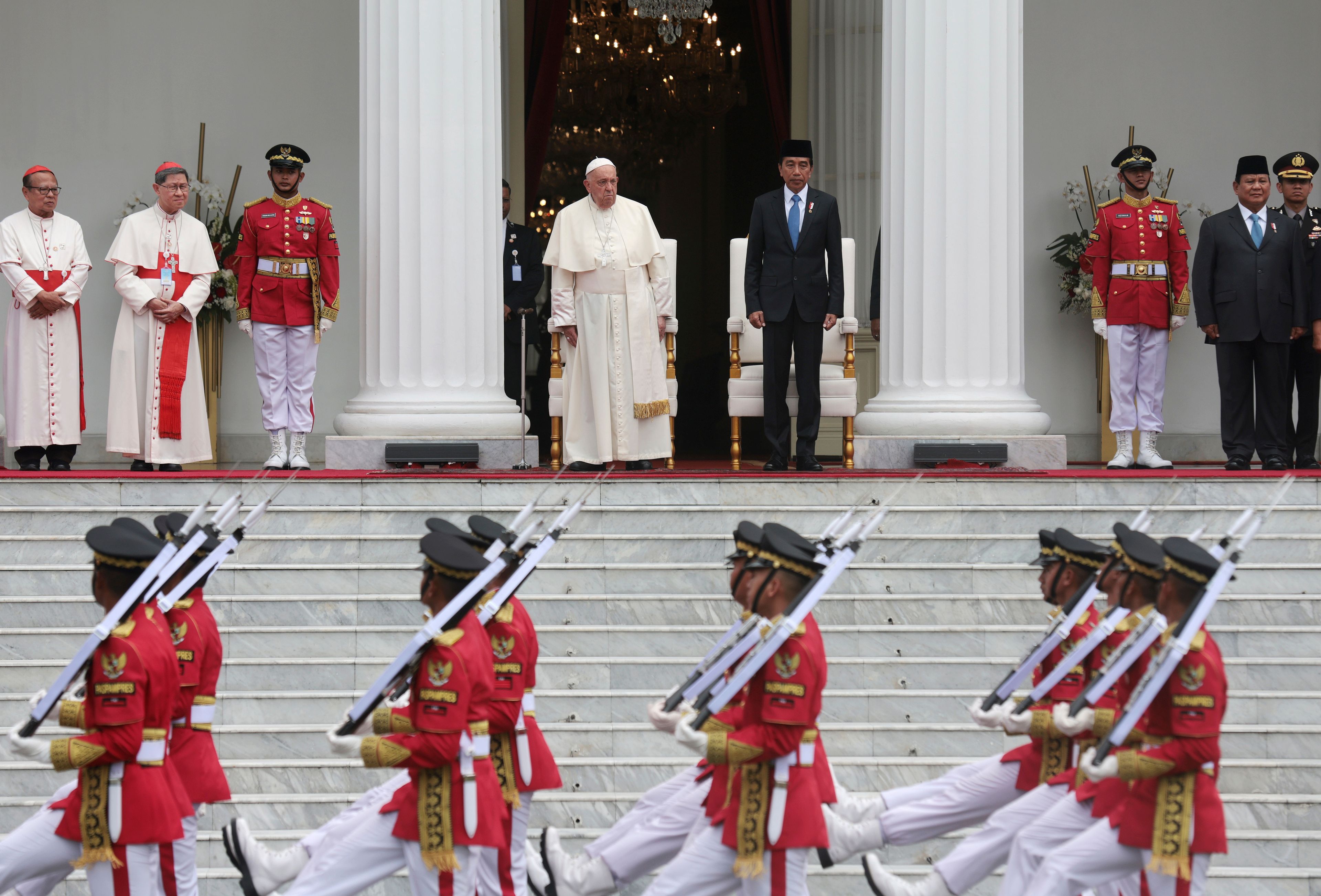 Pope Francis, top centre left, Indonesian President Joko Widodo, top centre right, and Indonesian President-elect Prabowo Subianto, top second right, review honor guards during a welcome ceremony at the Istana Merdeka Presidential Palace in Jakarta Wednesday, Sept. 4, 2024.