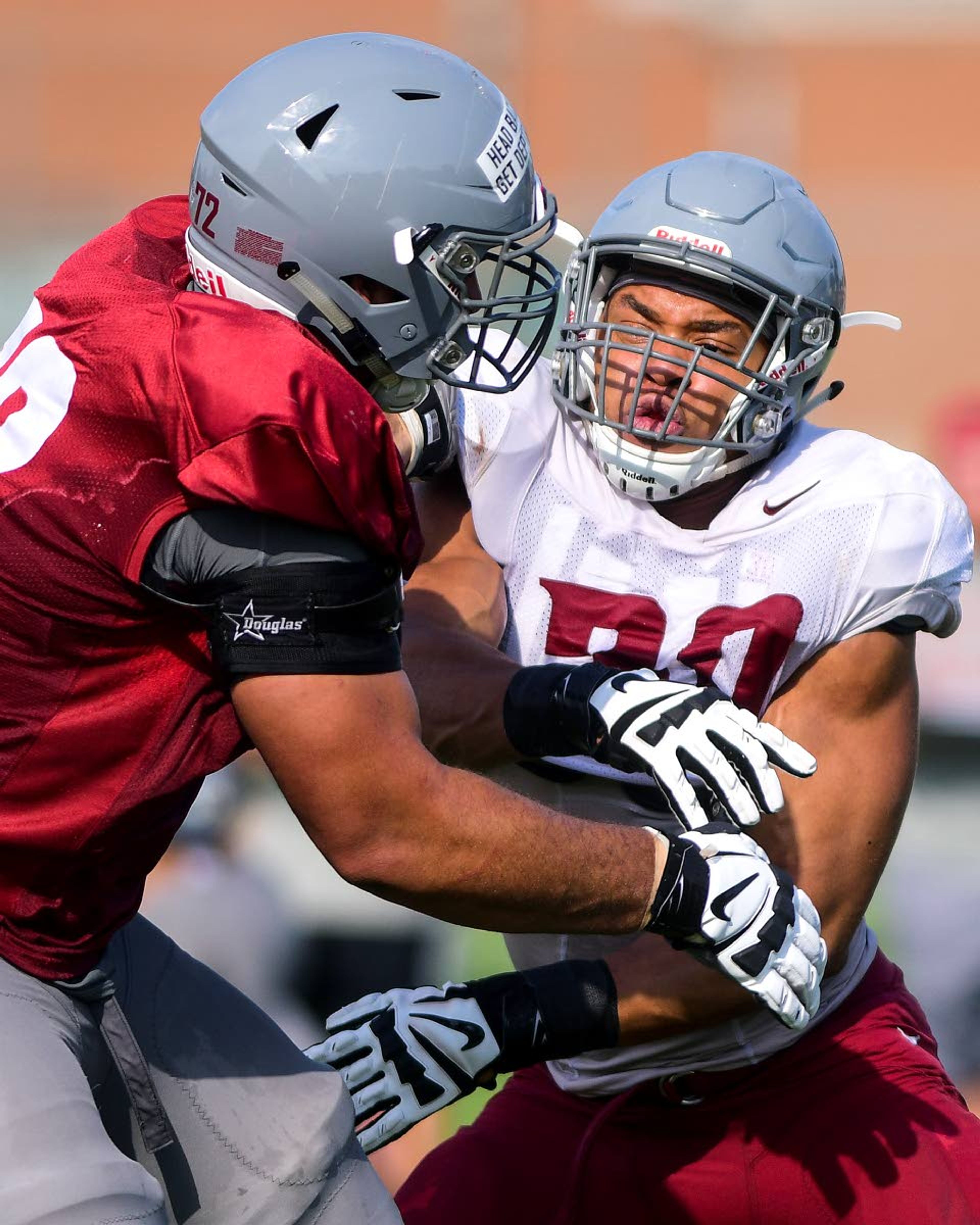 Washington State defensive lineman Nnamdi Oguayo (right) attempts to rush past offensive tackle Lucas Abraham during team drills on Tuesday in Lewiston.