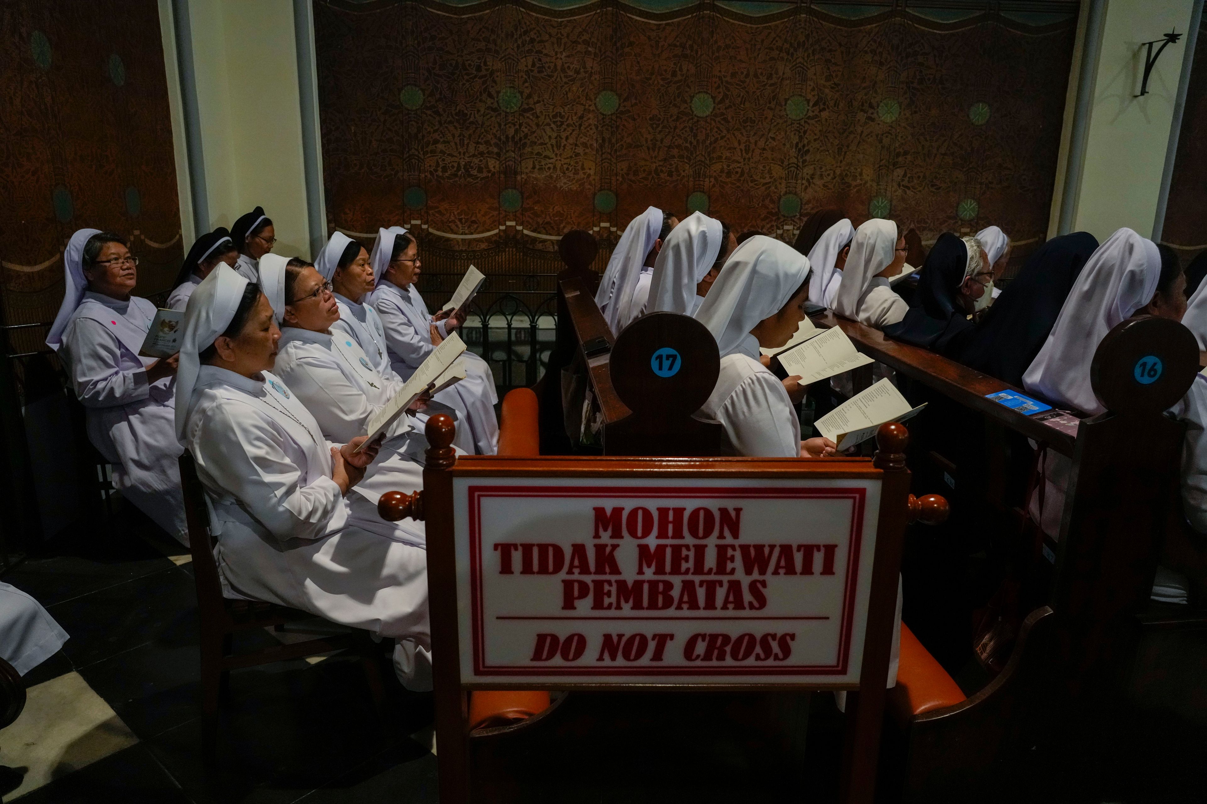 Nuns wait for the arrival of Pope Francis inside the Cathedral of Our Lady of the Assumption in Jakarta, Wednesday, Sept. 4, 2024. Francis had a packed first full day in Indonesia, meeting with outgoing President Joko Widodo and other Indonesian authorities at the presidential palace and then greeting Catholic priests, nuns and seminarians at Jakarta's main cathedral in the afternoon.