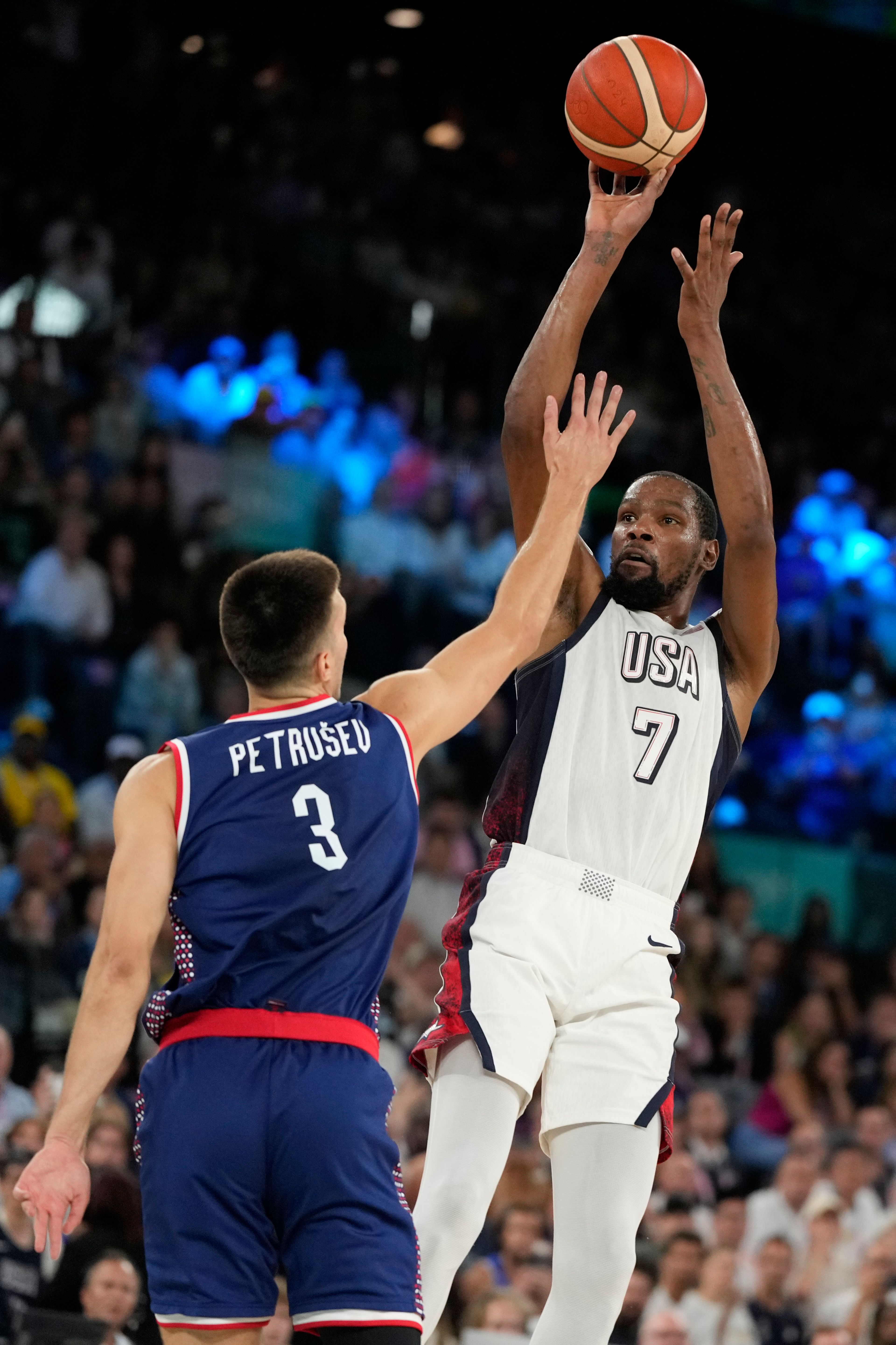 United States' Kevin Durant (7) shoots over Filip Petrusev (3), of Serbia during a men's semifinals basketball game at Bercy Arena at the 2024 Summer Olympics, Thursday, Aug. 8, 2024, in Paris, France. (AP Photo/Michael Conroy)