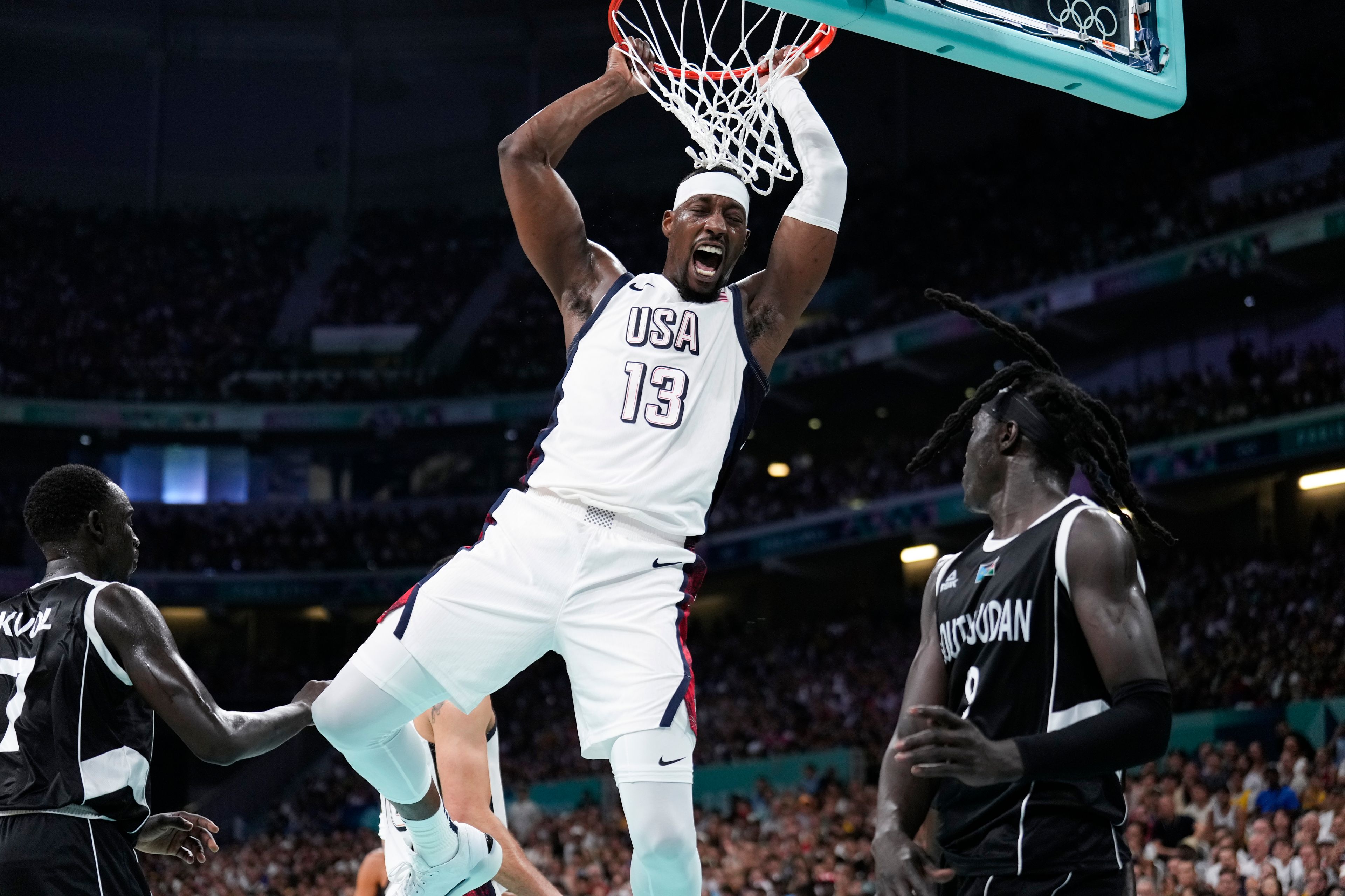 Bam Adebayo, of the United States, reacts after a dunk over Wenyen Gabriel, of South Sudan, in a men's basketball game at the 2024 Summer Olympics, Wednesday, July 31, 2024, in Villeneuve-d'Ascq, France. (AP Photo/Mark J. Terrill)