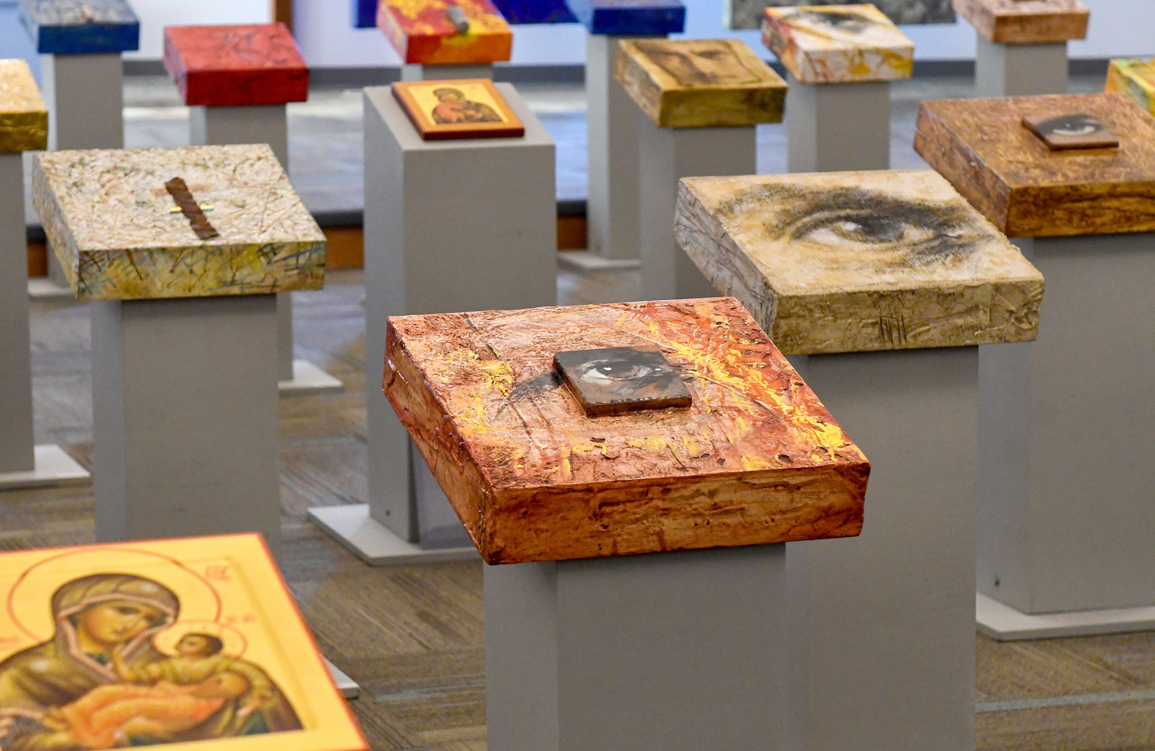 Icons and paintings sit on pedestals Thursday in a hall at St. James Episcopal Church as part of Ludmila Pawlowskas traveling exhibit, Icons in Transformation.