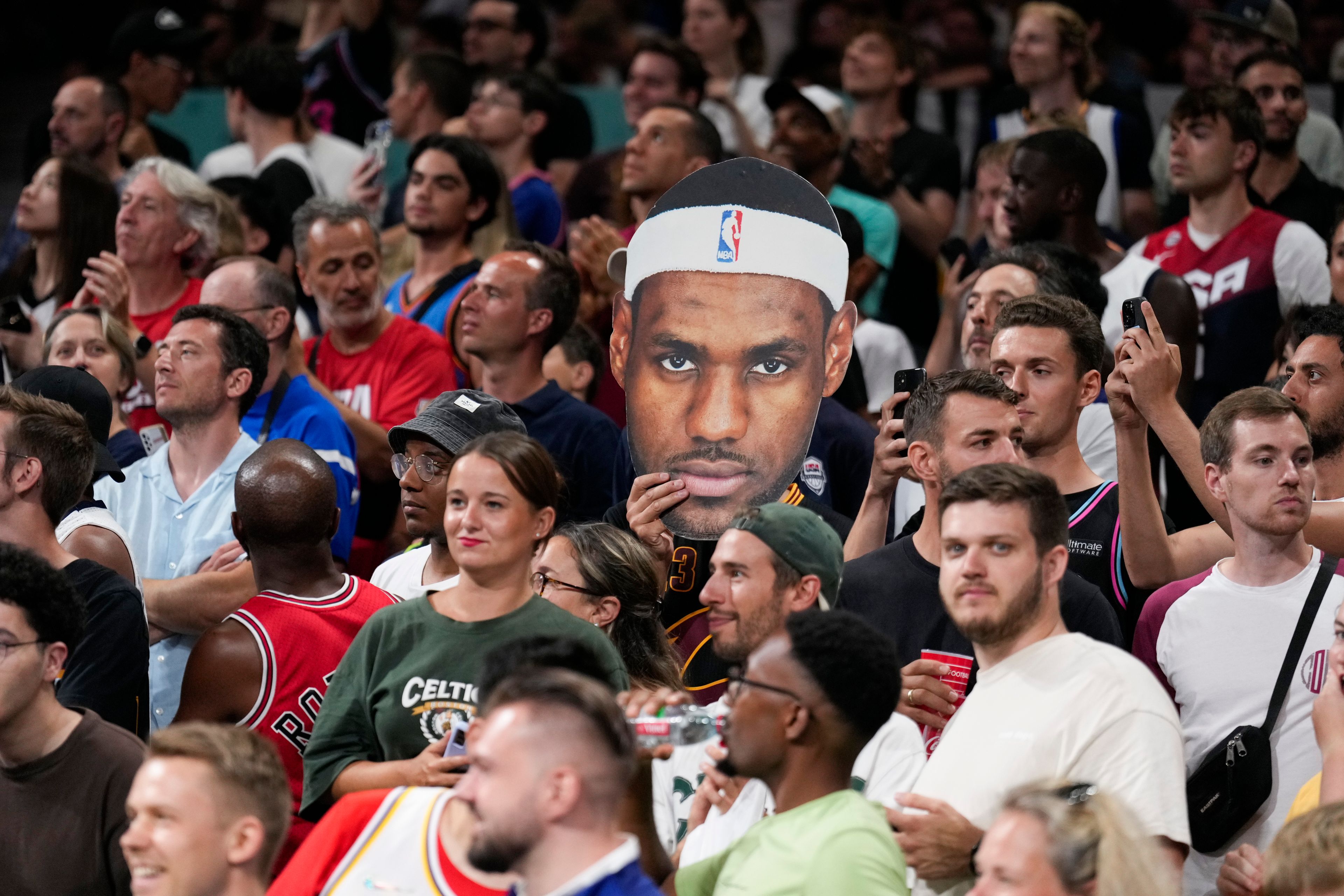 United States fans cheer before the start a men's basketball game\between the United States South Sudan at the 2024 Summer Olympics, Wednesday, July 31, 2024, in Villeneuve-d'Ascq, France. (AP Photo/Mark J. Terrill)