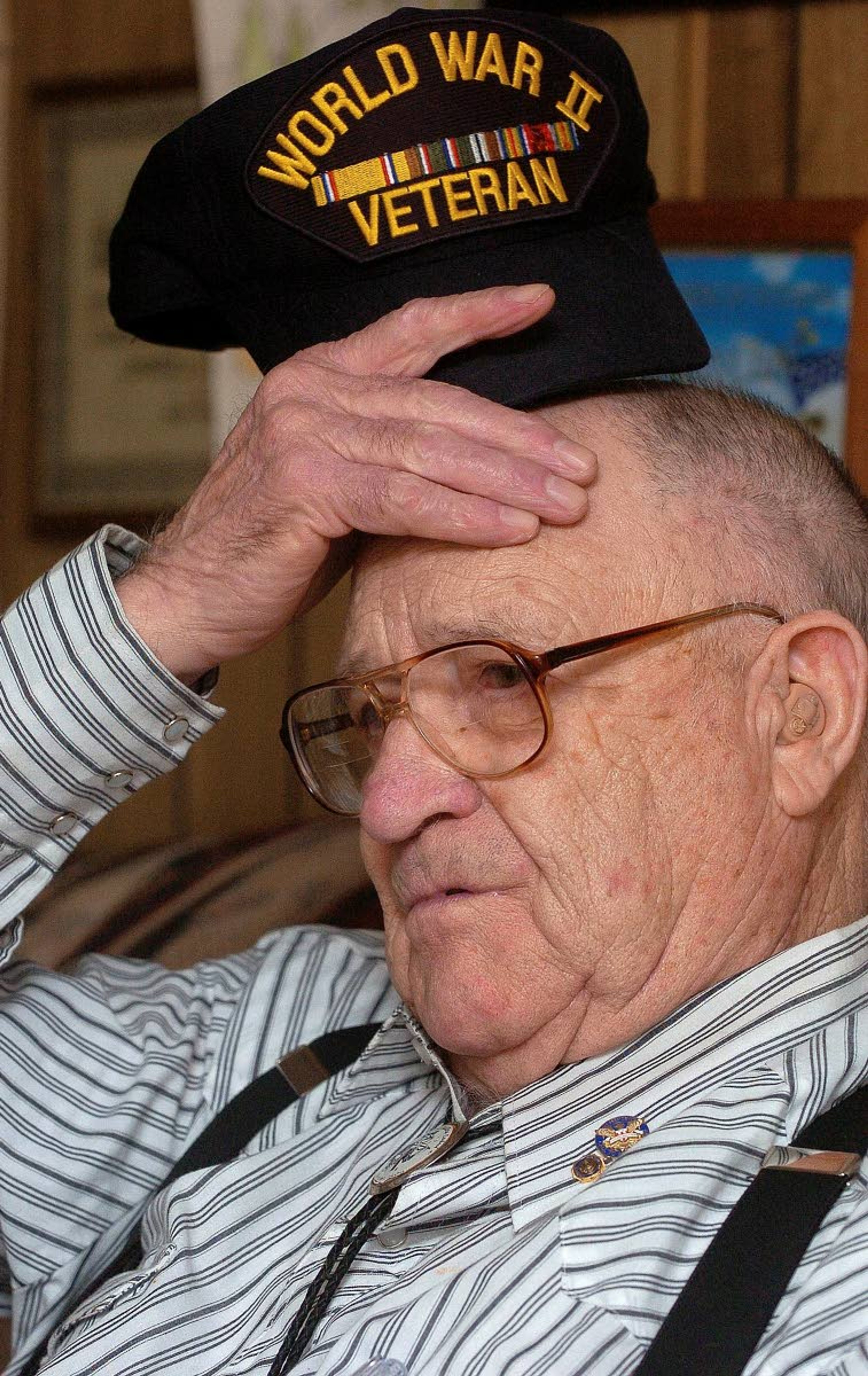 Ernest Bunch of Moscow rubs the scar he got on his forehead while serving in the Army during the World War II invasion of Europe in this Tribune file photo. Bunch, who earned numerous honors, including two Purple Hearts, died in 2014.