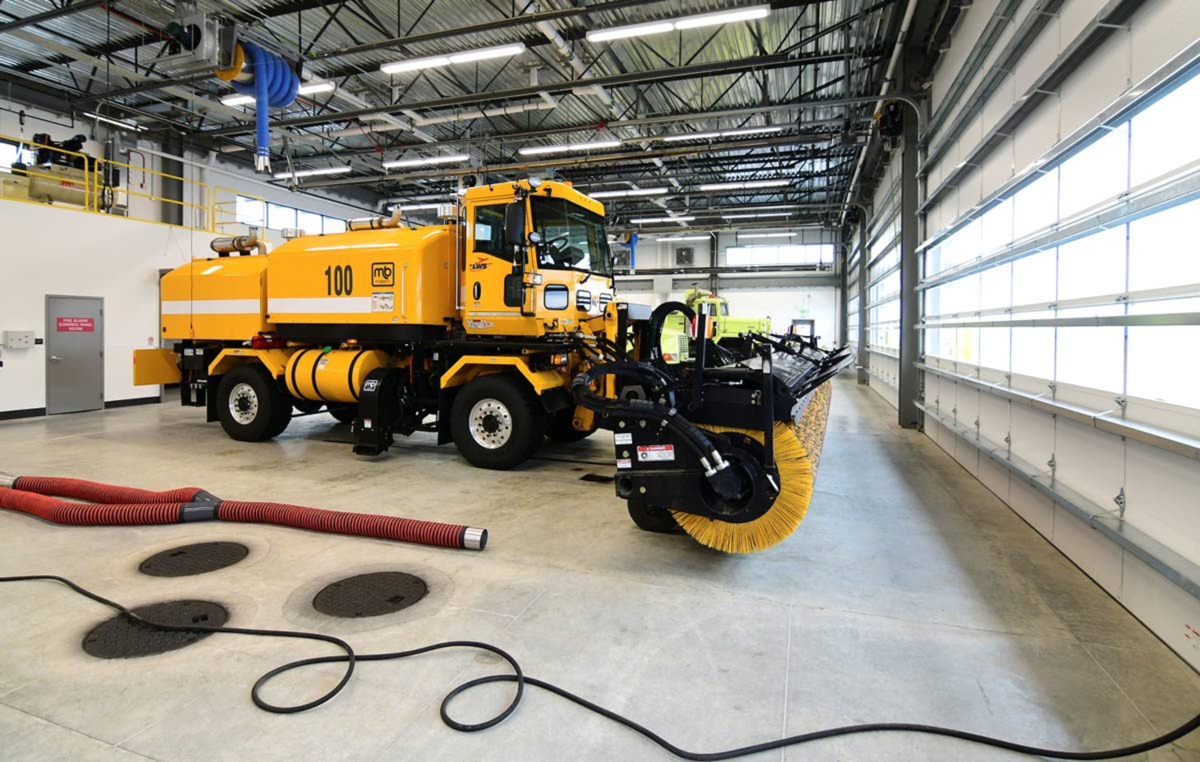 Much of the new building houses the runway maintenance equipment, including a new high-speed sweeper.