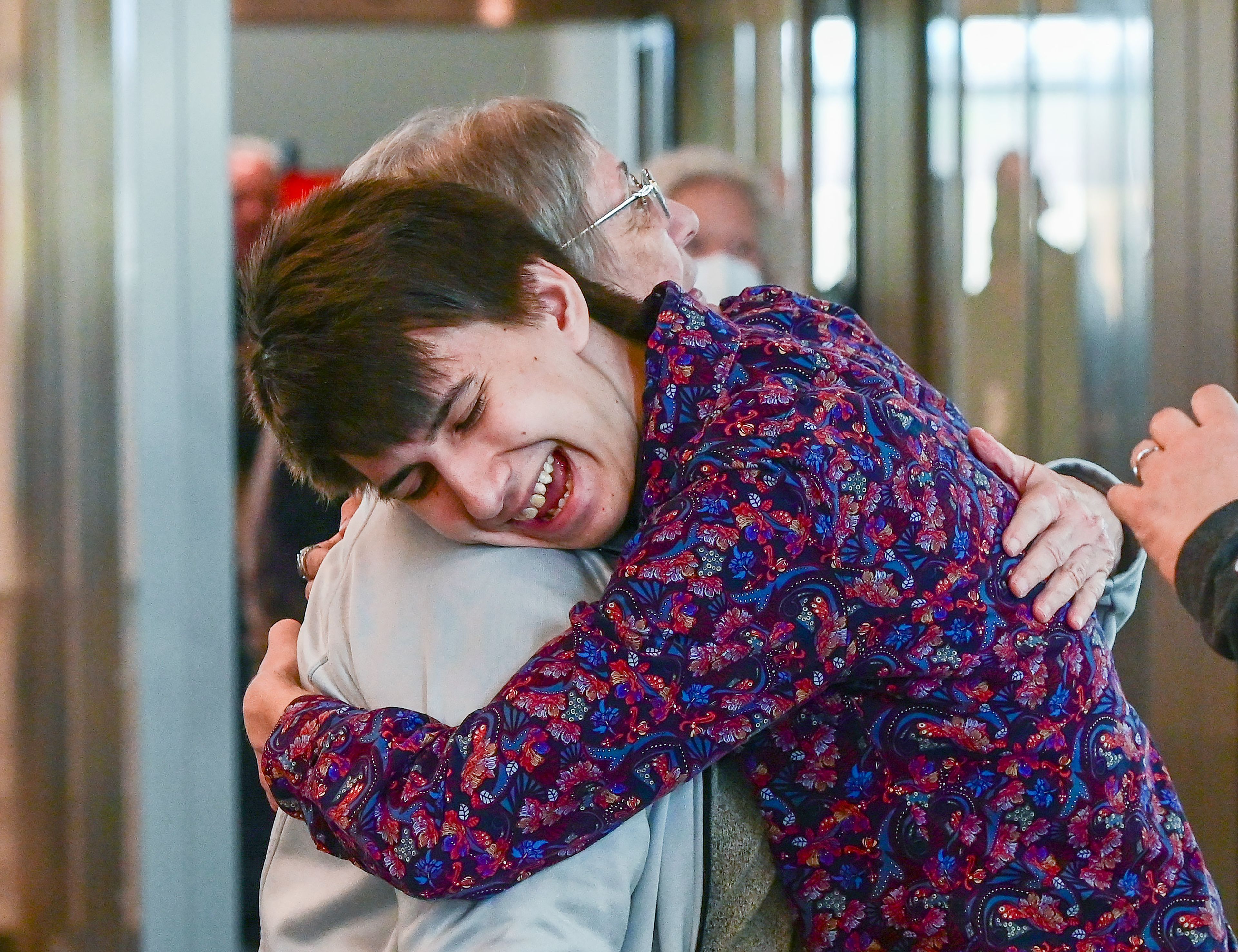 Dorothy Smith receives a hug from Brandon Bowman, front, as Smith arrives to visit family and watch a grandson’s high school graduation at the new Pullman-Moscow Regional Airport terminal on its first day of use in Pullman on Wednesday.