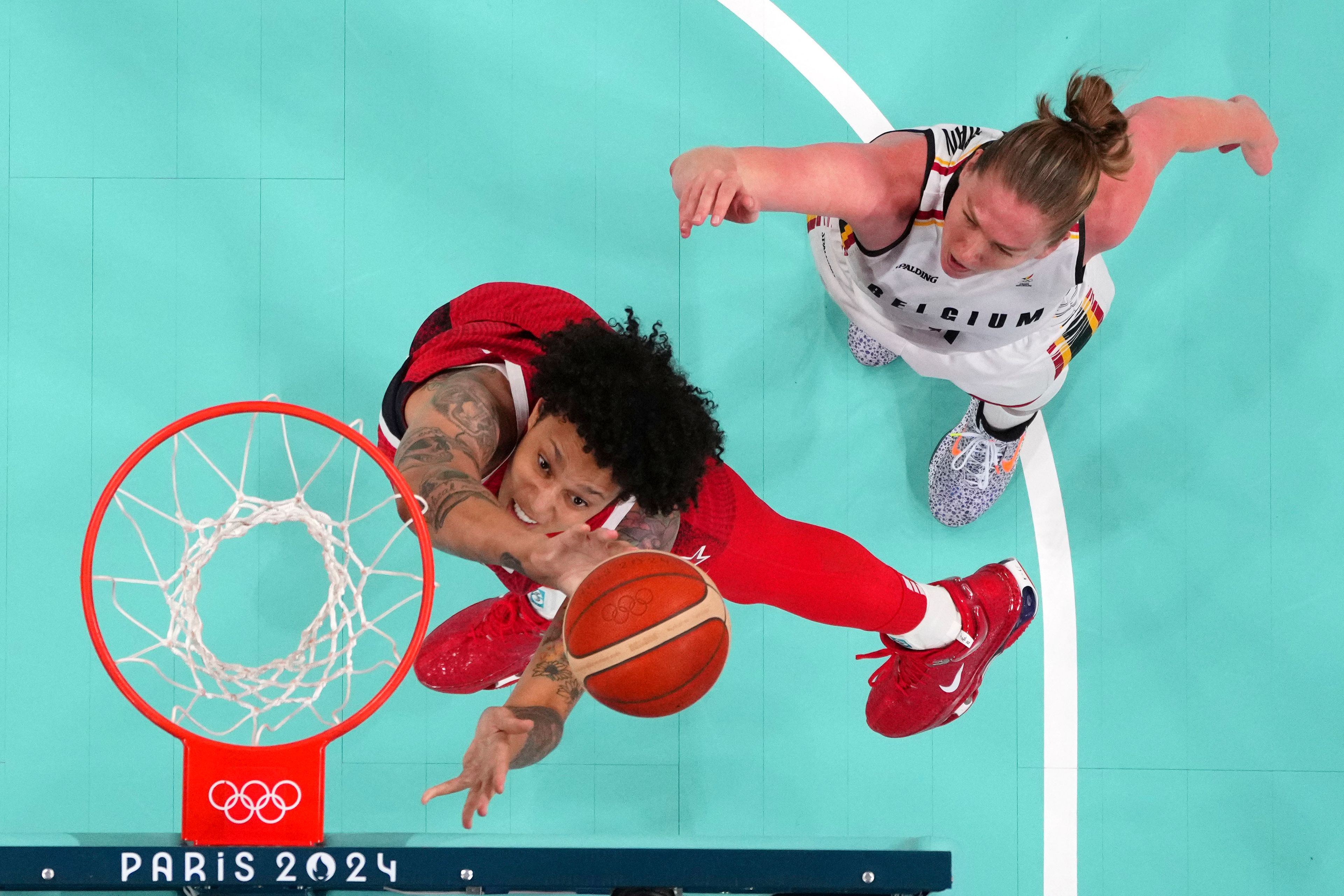 United States' Brittney Griner, left, shoots as Belgium's Emma Meesseman defends in a women's basketball game at the 2024 Summer Olympics, Thursday, Aug. 1, 2024, in Villeneuve-d'Ascq, France. (Evelyn Hockstein/Pool Photo via AP)