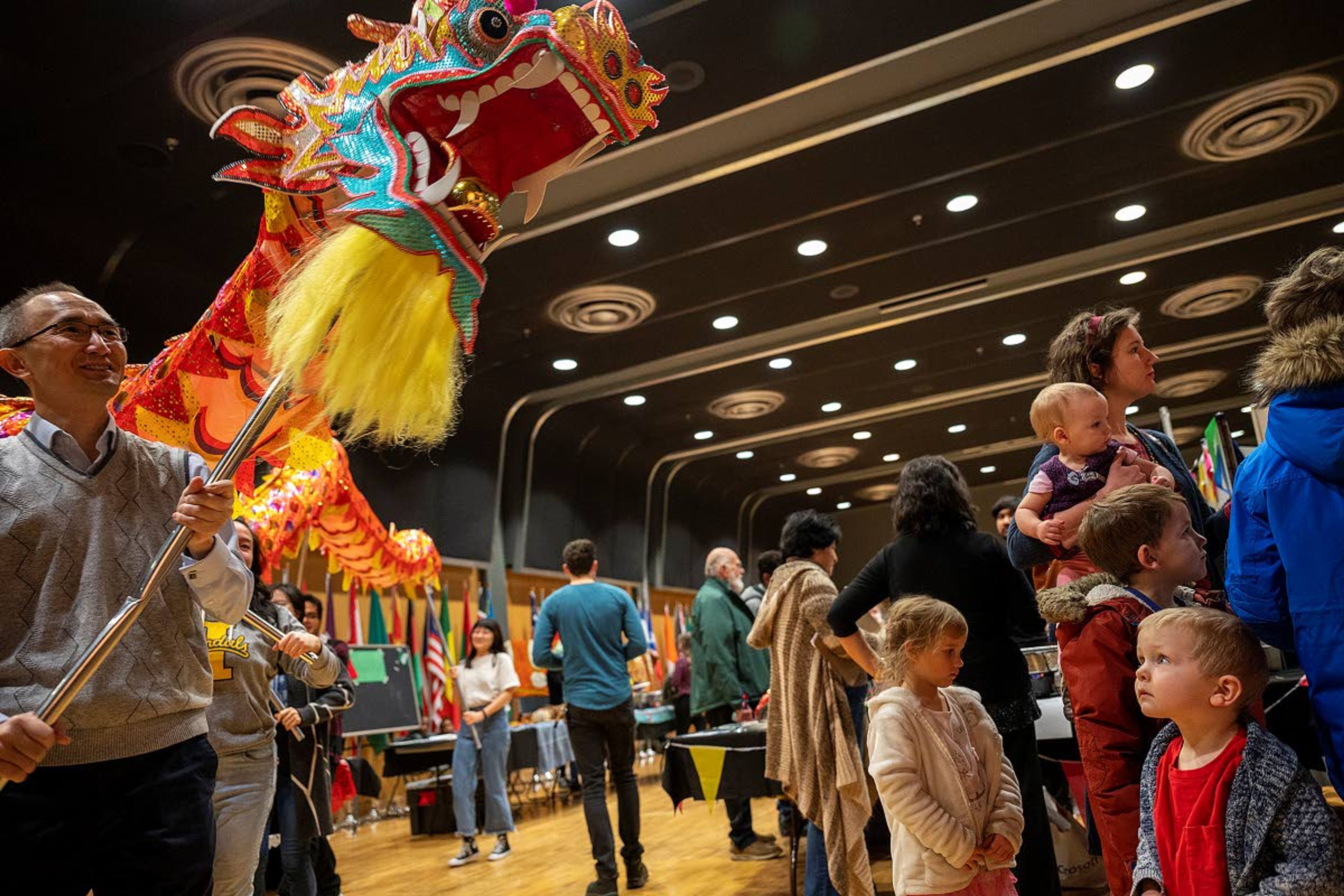 A young boy looks unsure as a giant dragon being paraded around the Pitman Center by performers from the Confucius Institute turns the corner and heads his way during the Cruise the World 2020 event Saturday at the University of Idaho in Moscow. Hundreds of people showed up to the event that featured exhibits, food, music and dances from an amalgam of cultures across the globe.