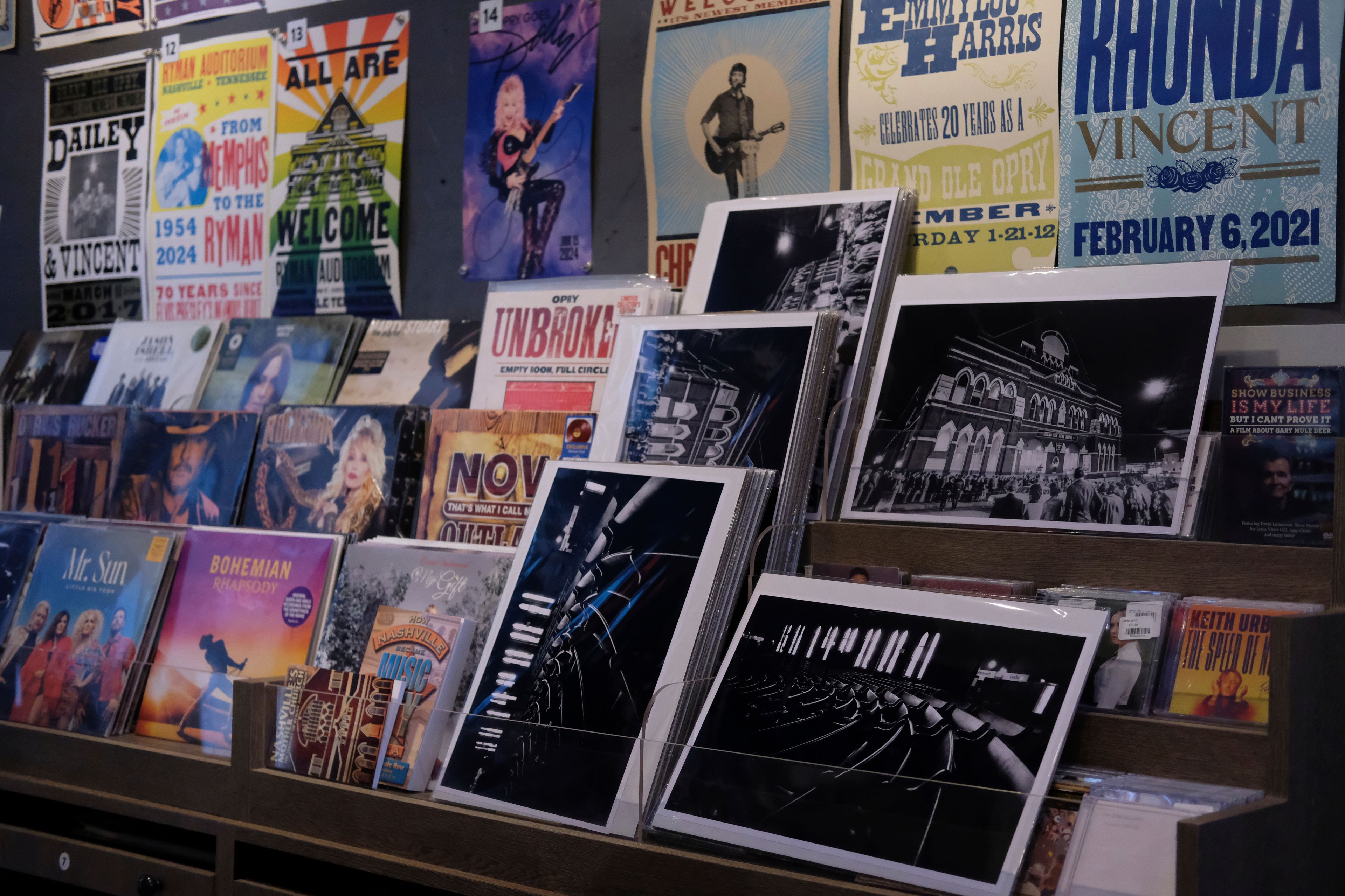 Posters of Dolly Parton and other artists who have played at the Ryman Auditorium are displayed at the concert venue's gift shop in Nashville, Tenn., on July 30, 2024.