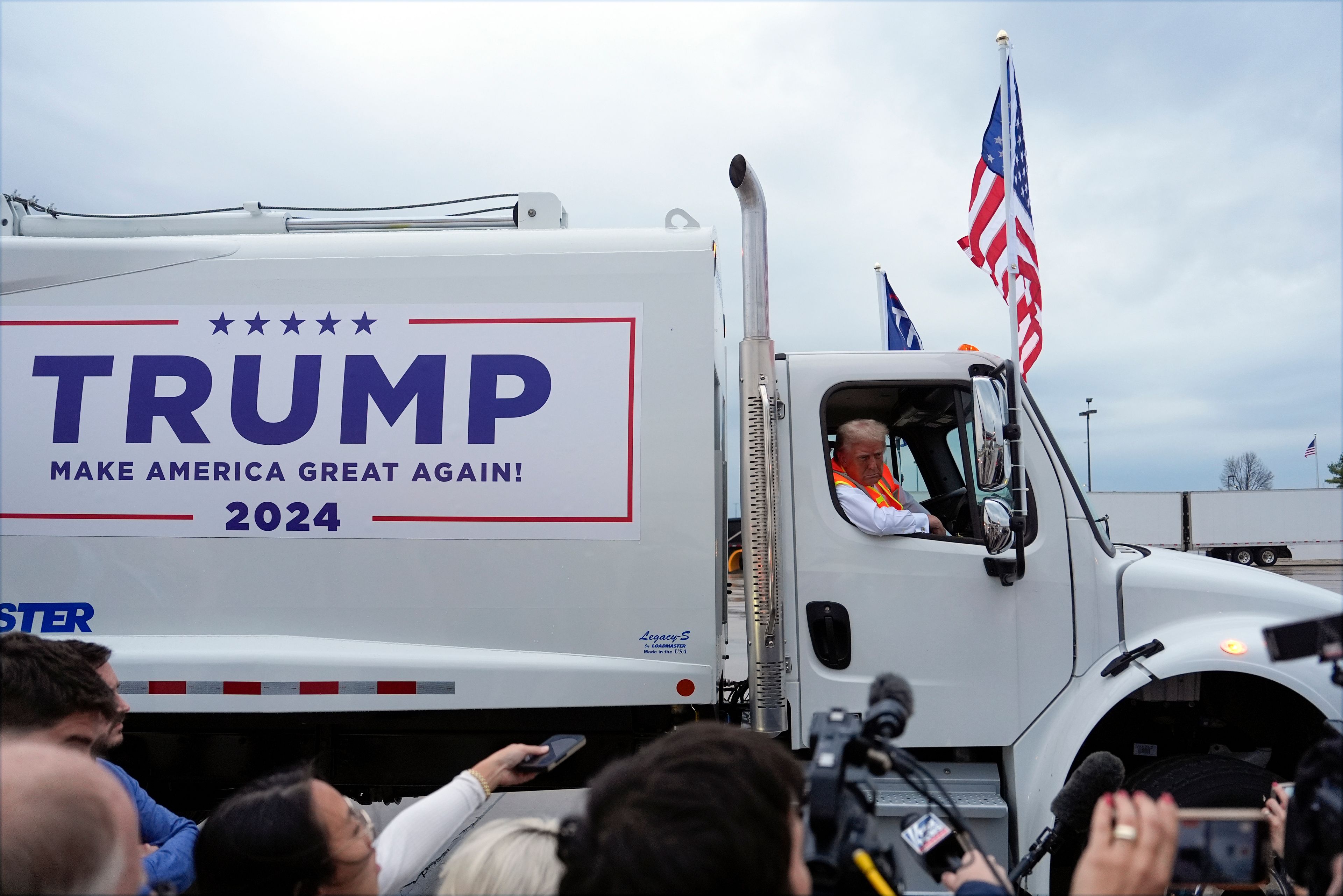 Republican presidential nominee former President Donald Trump talks to reporters as he sits in a garbage truck Wednesday, Oct. 30, 2024, in Green Bay, Wis. (AP Photo/Julia Demaree Nikhinson)