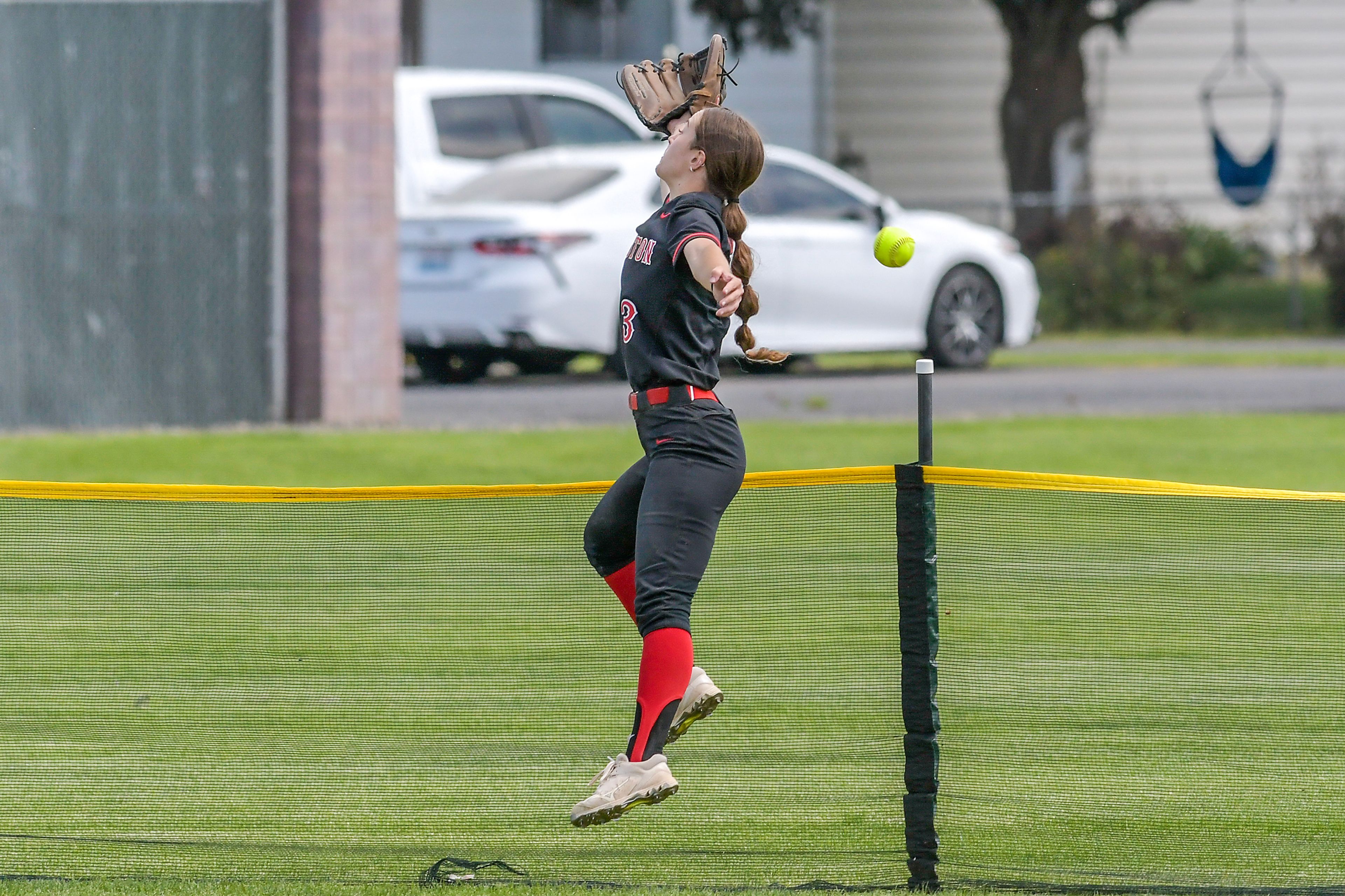 Clarkston center fielder Leah Copeland attempts to make a catch on a Shadle Park home run during an inning of the District Championship Game Saturday in Clarkston.